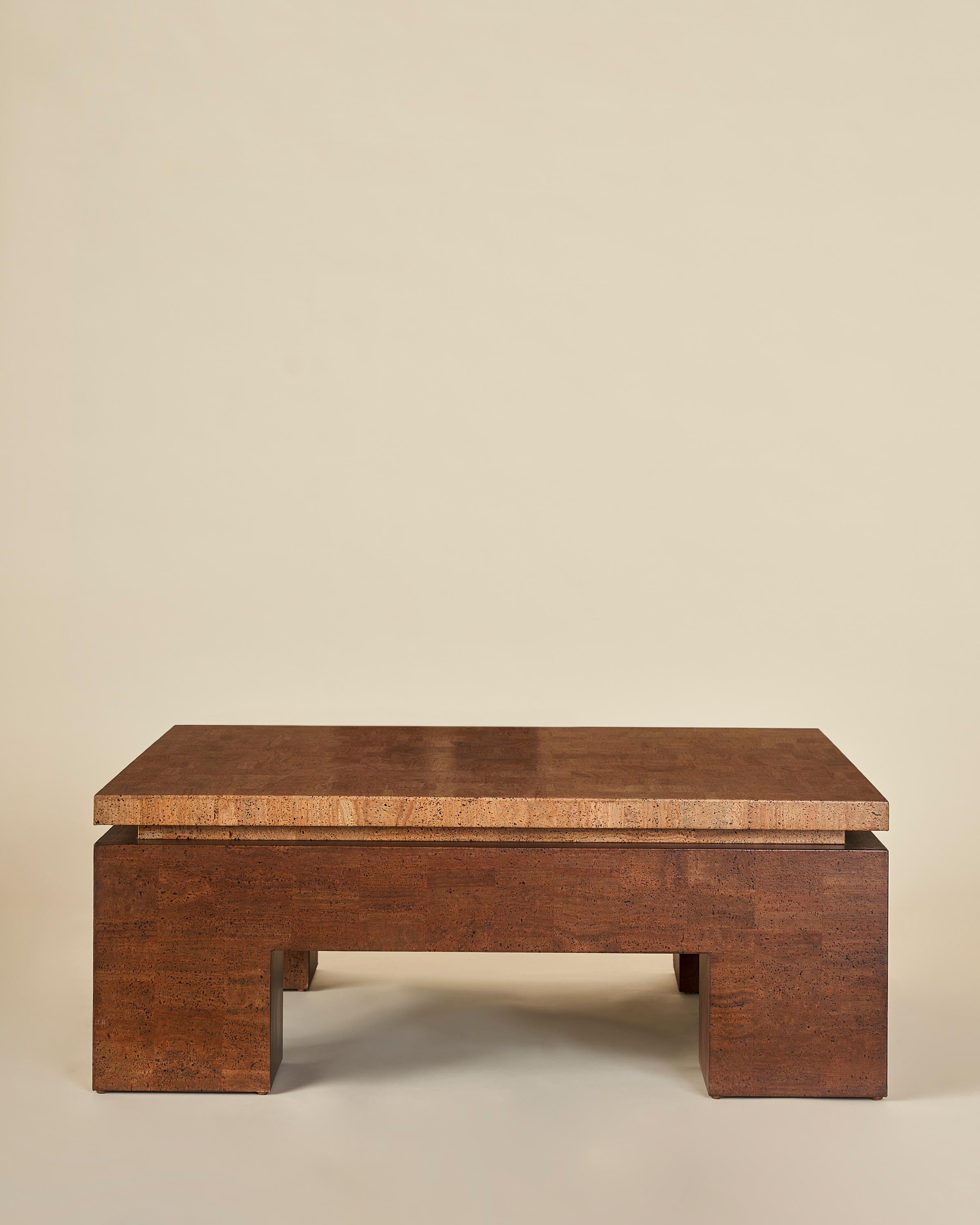A handcrafted square coffee table constructed in two tones of cork. The table boasts a floating top that rests upon a base of generous proportions.

Our collection pays homage to the everlasting idea of home, a place that is alive as its own