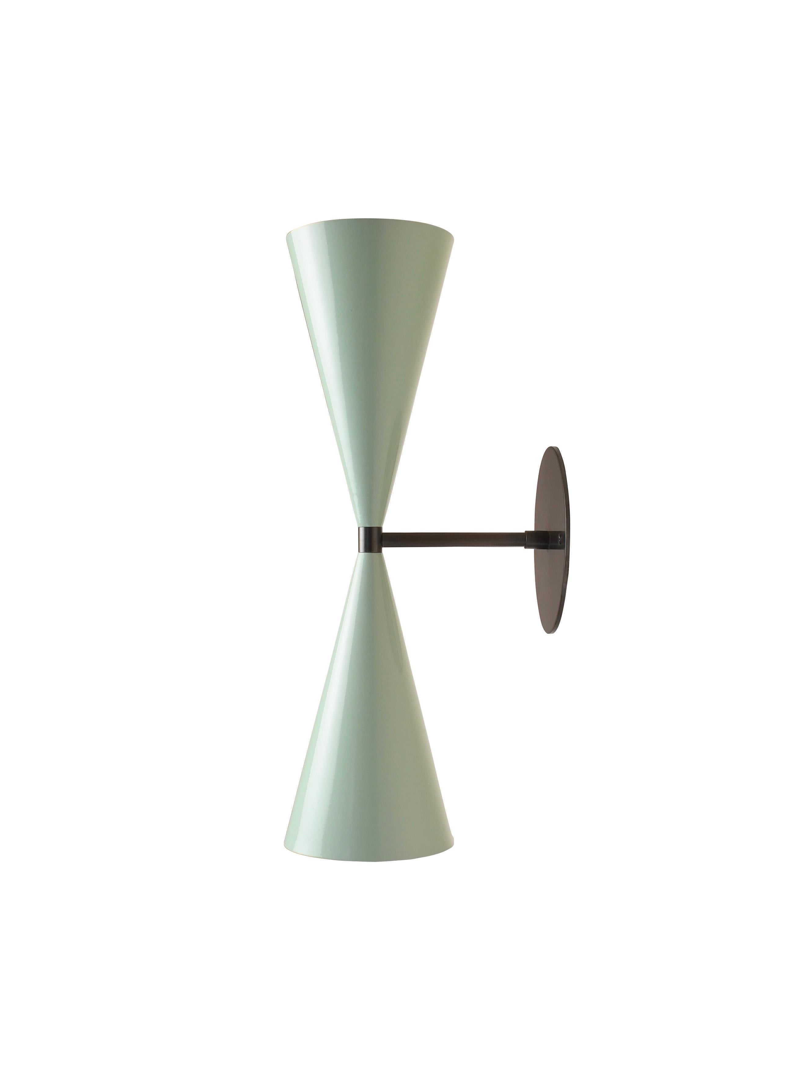 The Tuxedo wall sconce or reading light designed by Blueprint Lighting, 2018. This design is strongly influenced by both French and Italian Mid-Century Modernism.

Enamel shown is our Sweet Mint color and hardware is shown in Dark Bronze. You may