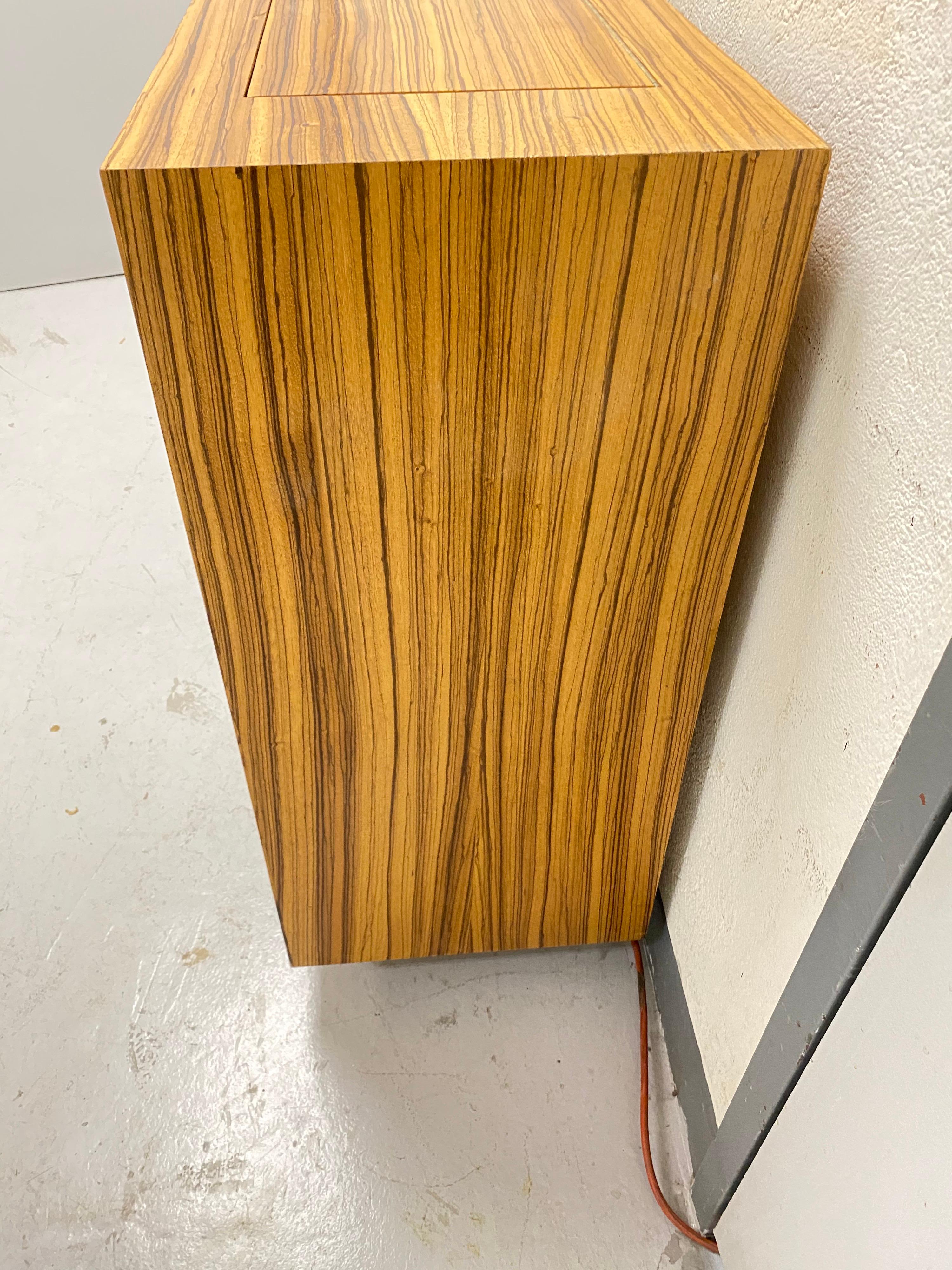 Modern tiger maple and zebrawood veneer cabinet. Lift TV mechanism with remote
With nexus 21 lift TV mechanism to raise and lower flat screen TVs.
Measures: Opening 44.75 wide x 10.5 deep.
Paper on doors can be changed.

Additional videos available