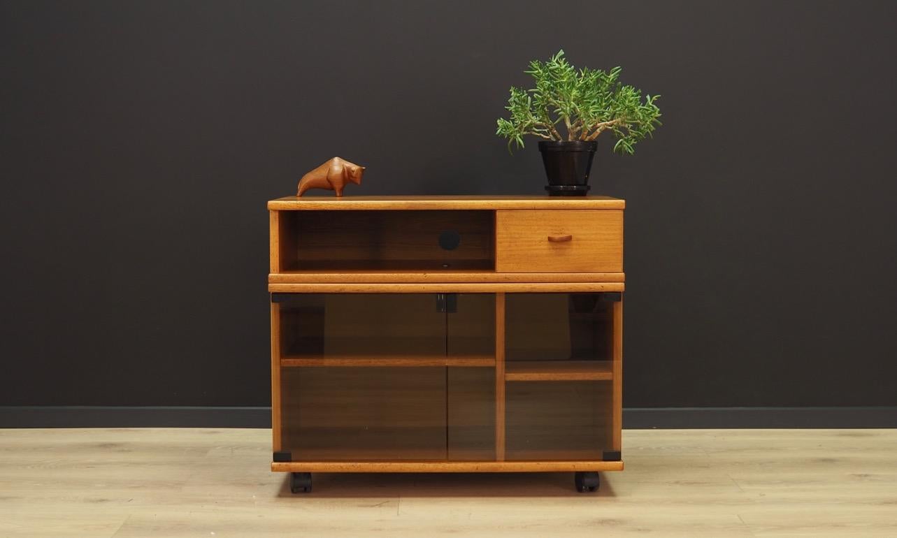 Fantastic TV cabinet from the 1960s-1970s, Scandinavian design, Minimalist form. The surface of the furniture finished with teak veneer. Two shelves behind glass doors. Maintained in good condition (minor bruises and scratches), directly for
