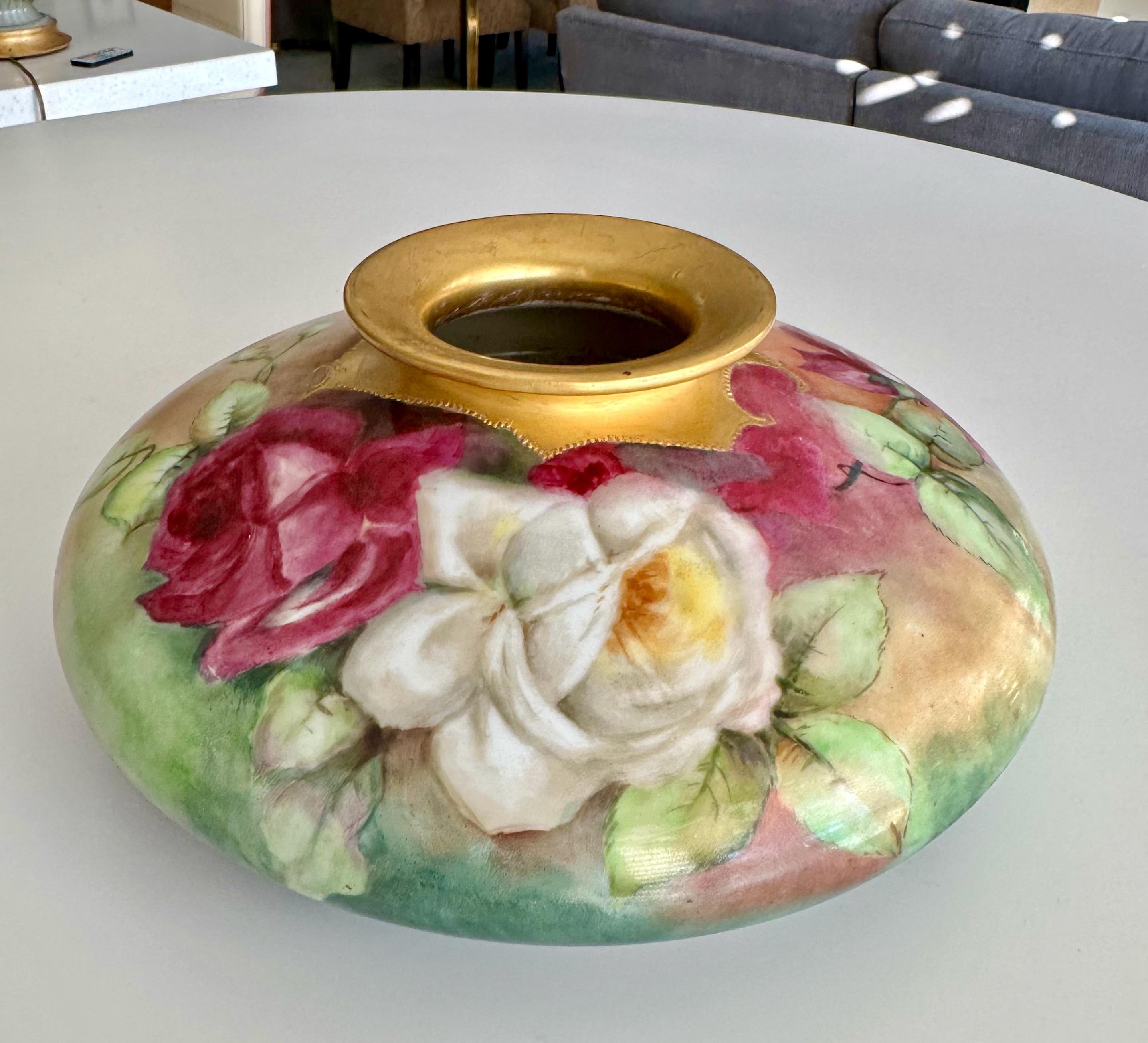 French hand painted floral porcelain Tressemann & Vogt Limoges squat vase. Expertly decorated with red and white roses surrounded by soft shades of green foliage. Beautiful piece dating from the early 1900s. 