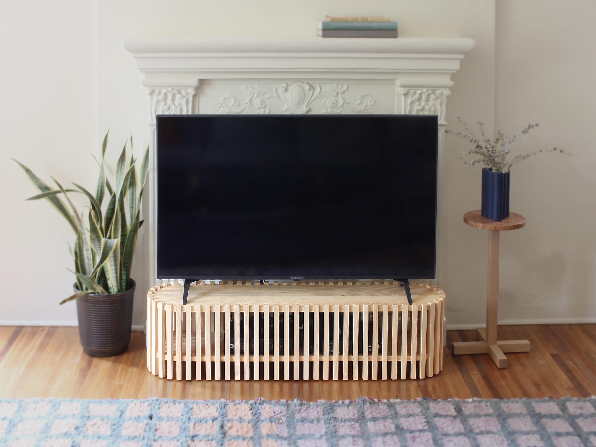 Light and airy yet robust with functionality, this television stand not only places your TV at an optimal viewing height but also houses the necessary equipment such as wifi router, apple tv, cable box etcetera. The basket like enclosure hides the