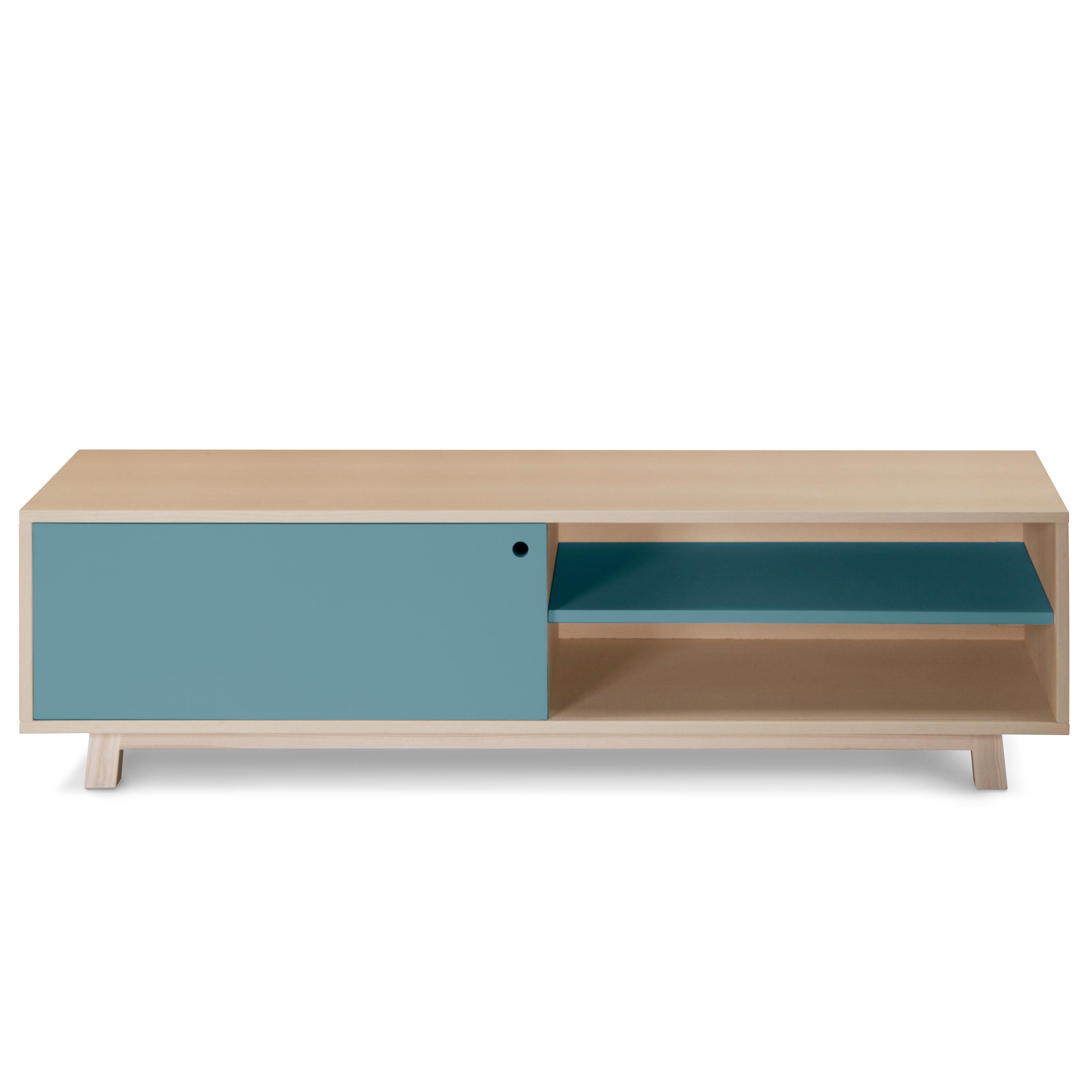 This TV stand with one sliding door is designed by Eric Gizard - Paris.

It is 100% made in France with solid and veneer ash and and lacquered MDF doors. 

To pull the door, use the round eyelet. 
An adjustable wooden shelf on cleats is placed
