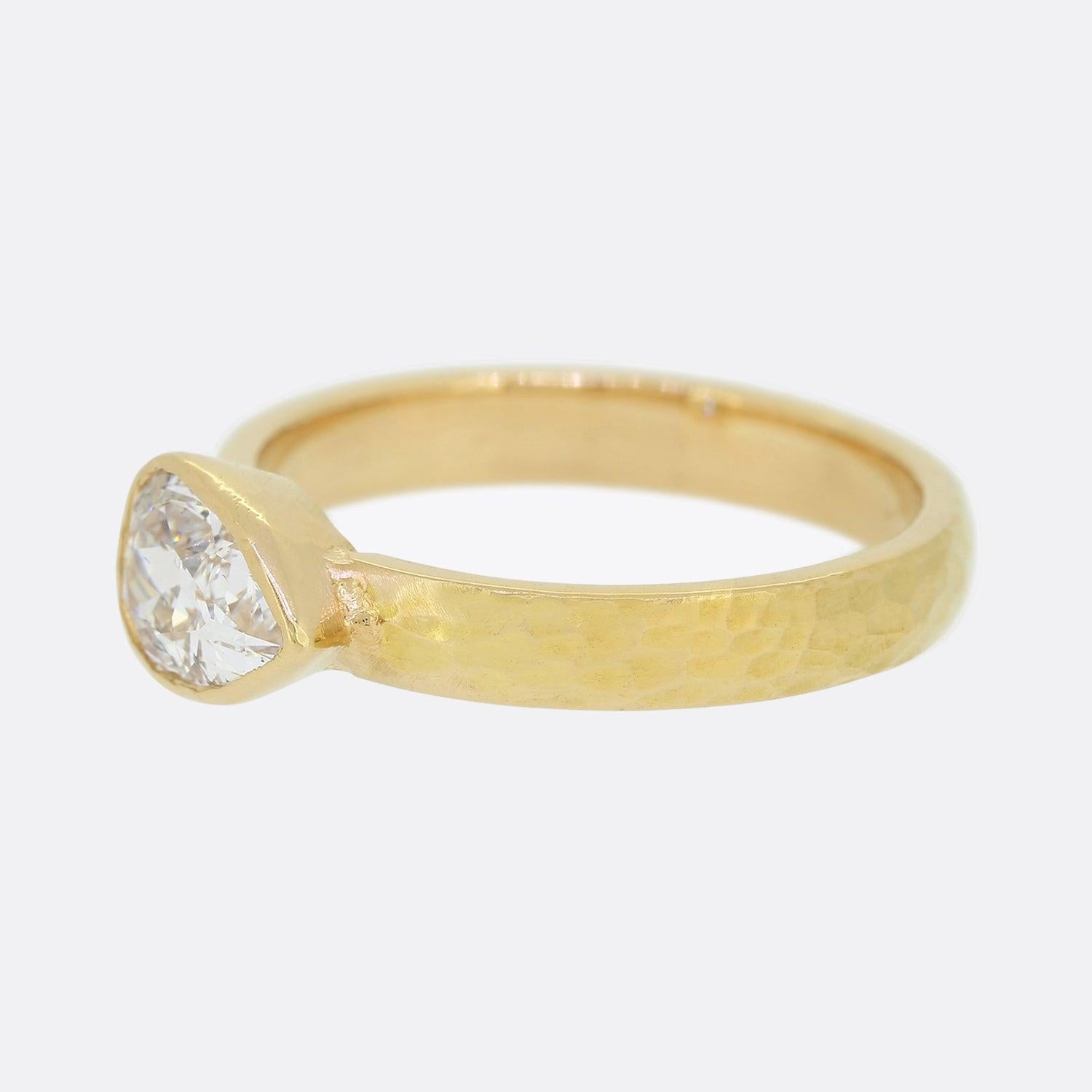 This is a beautifully created 22ct yellow gold solitaire diamond ring. The ring features a hammered finish and plays host to a 0.91 carat pear shaped old cut diamond. The band is a rich gold colour as you would expect from 22ct and this would make a