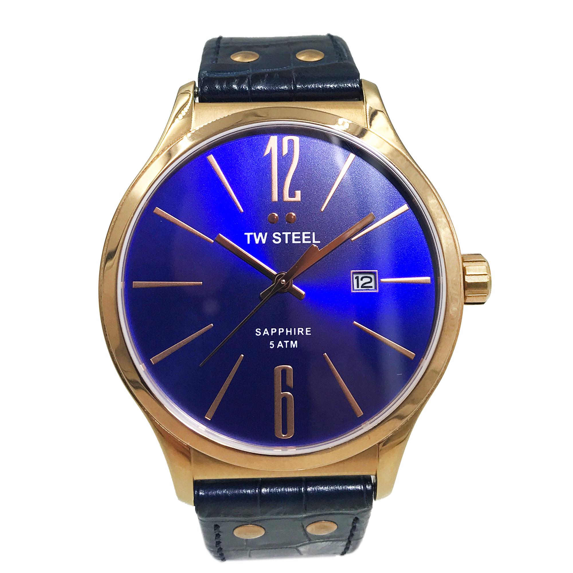 The watch has minor scratches under close inspection. Comes with original box and papers. Missing hanging tags. Quartz movement Scratch Resistant Sapphire Blue dial Rose gold plated steel case with blue leather strap Arabic Numerals mark the 6 and
