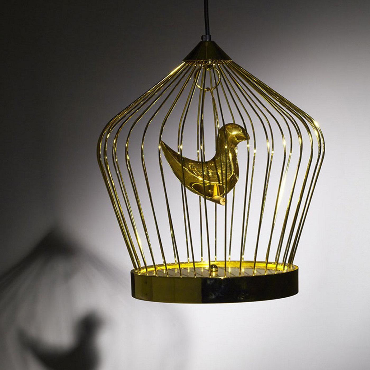 This refined and whimsical suspension lamp by Jake Phipps is available both in 24-karat gold plating (featured) and black-painted metal, as well as in two sizes. A modern revisitation of popular practice of keeping canary birds in ornate cages at