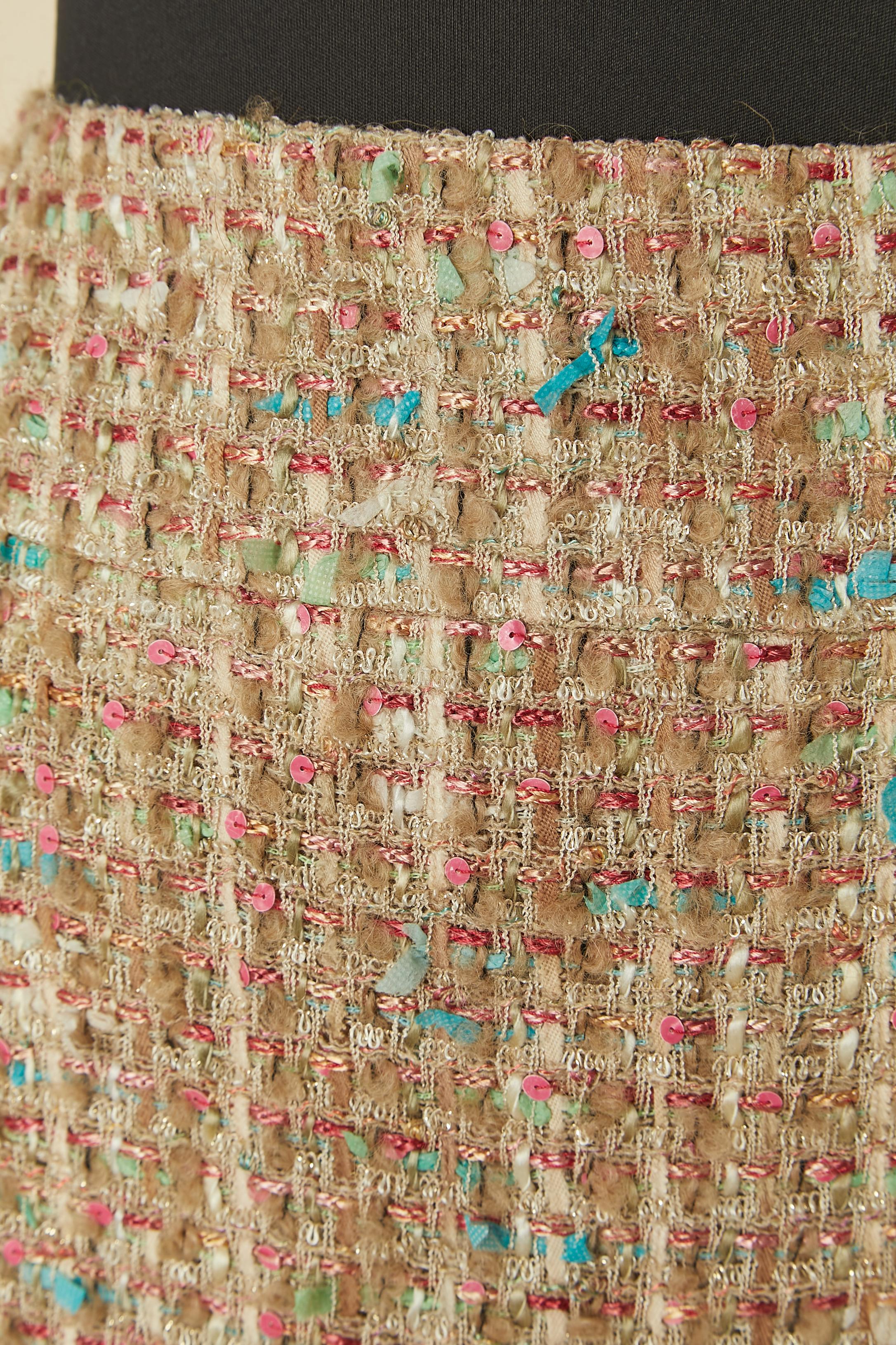 Tweed skirt with jacquard cashmere edge. Main fabric composition ( Tweed) = nylon, wool, polyester, acrylic, alpaca and rayon) 
Knit jacquard bottom edge composition: cashmere and wool. Silk lining. Invisible zip closure on the top middle back.