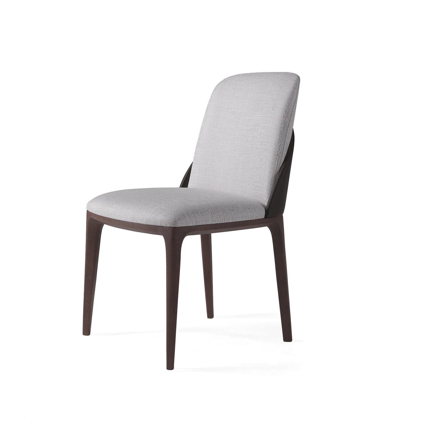 The sinuous design of the Tweet Chair will elegantly suit a modern dining room ensemble. Lightly padded and upholstered in heather-gray fabric, the seat and backrest have rounded corners that soften the sculptural silhouette, their exclusive feature