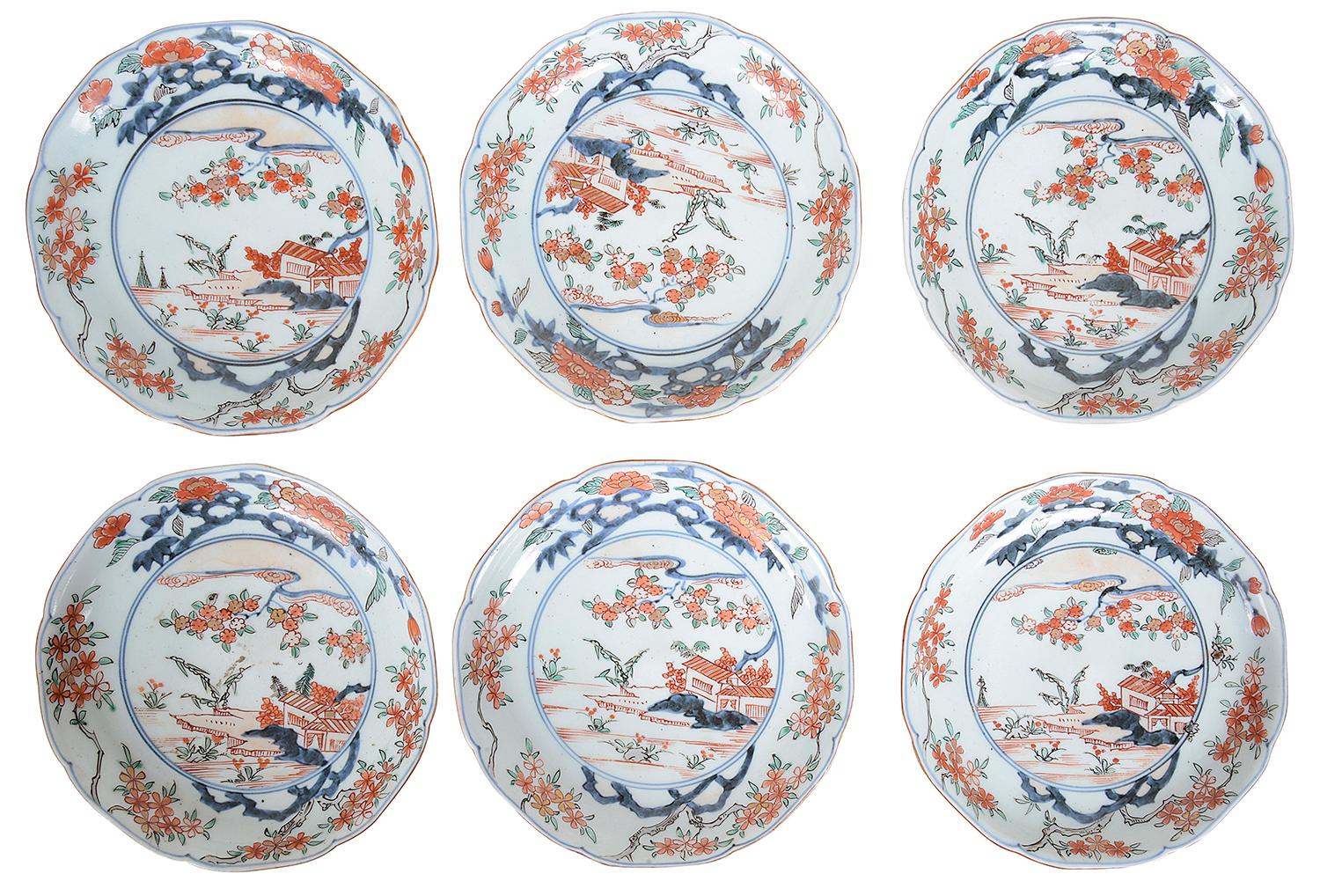 A rare set of twelve 18th century Japanese Imari plates, each with wonderful bold orange and blue colours, the boarders with blossom trees, inset panel depicting lake side buildings. Measure: 8