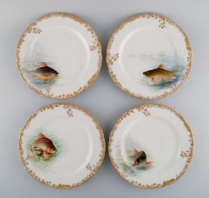 Twelve antique Pirkenhammer porcelain dinner plates with hand-painted fish and gold decoration. 
High quality, the early 1900s.
Diameter: 24.5 cm.
In excellent condition.
Stamped.