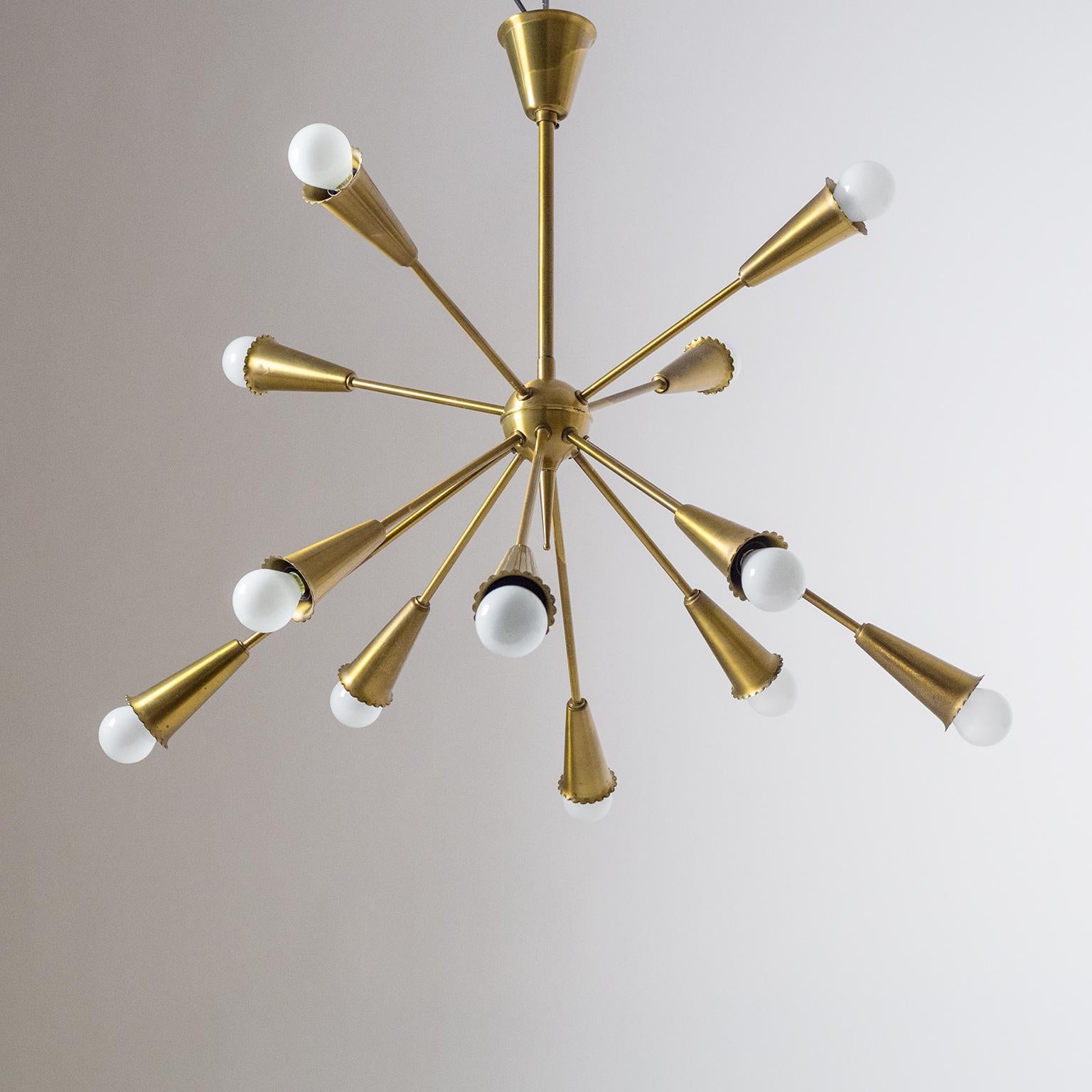 Beautiful all brass sputnik chandelier from the 1950s attributed to Hans Bergström. Twelve arms in two lengths emanate from a brass centerpiece in firework manner. Each arm ends in a brass socket cover with a rare 'frilled' rim. Very good original