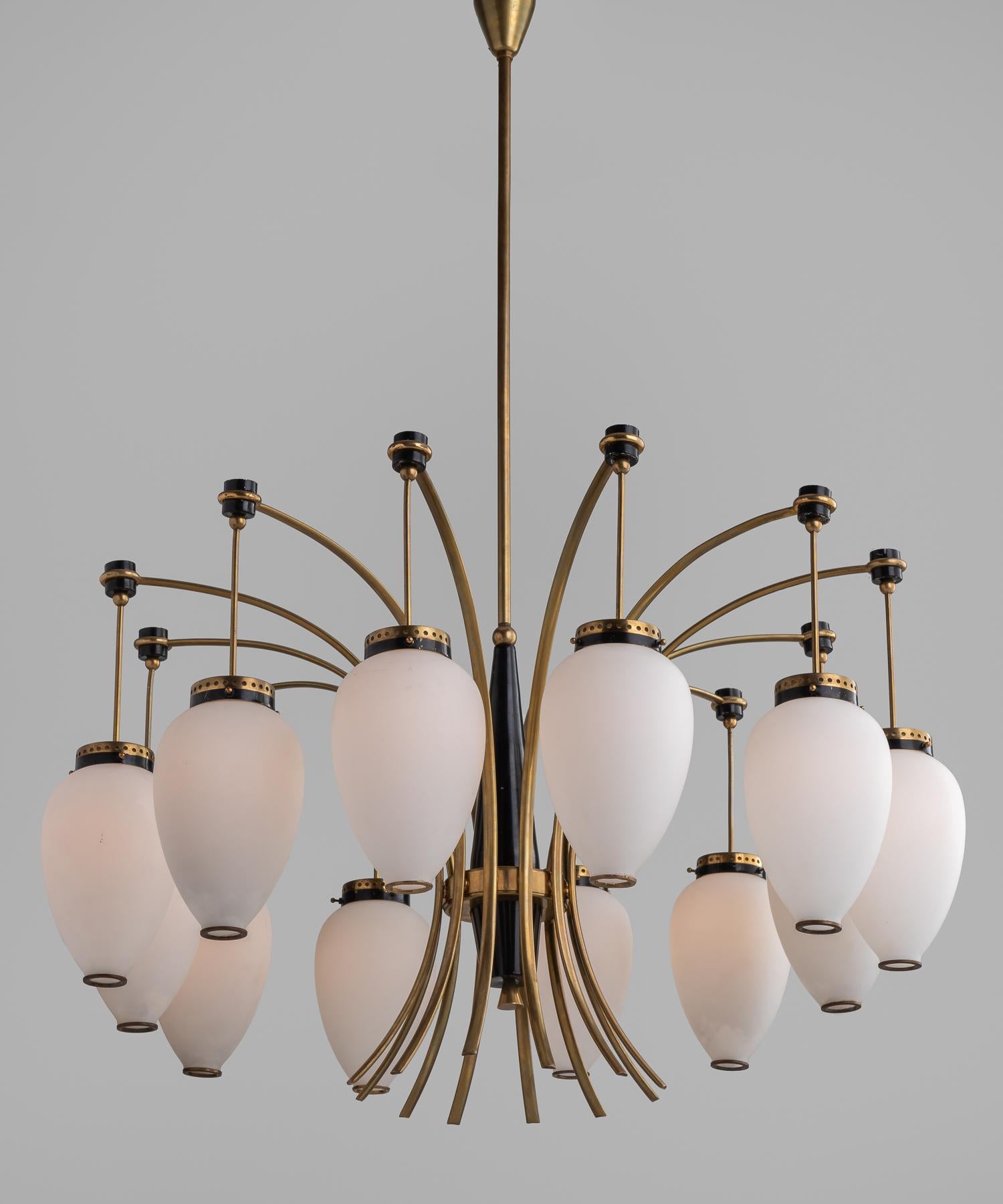 Twelve-arm opaline and brass chandelier, Italy, circa 1960.

Teardrop opaline glass shades hanging from brass arms.

