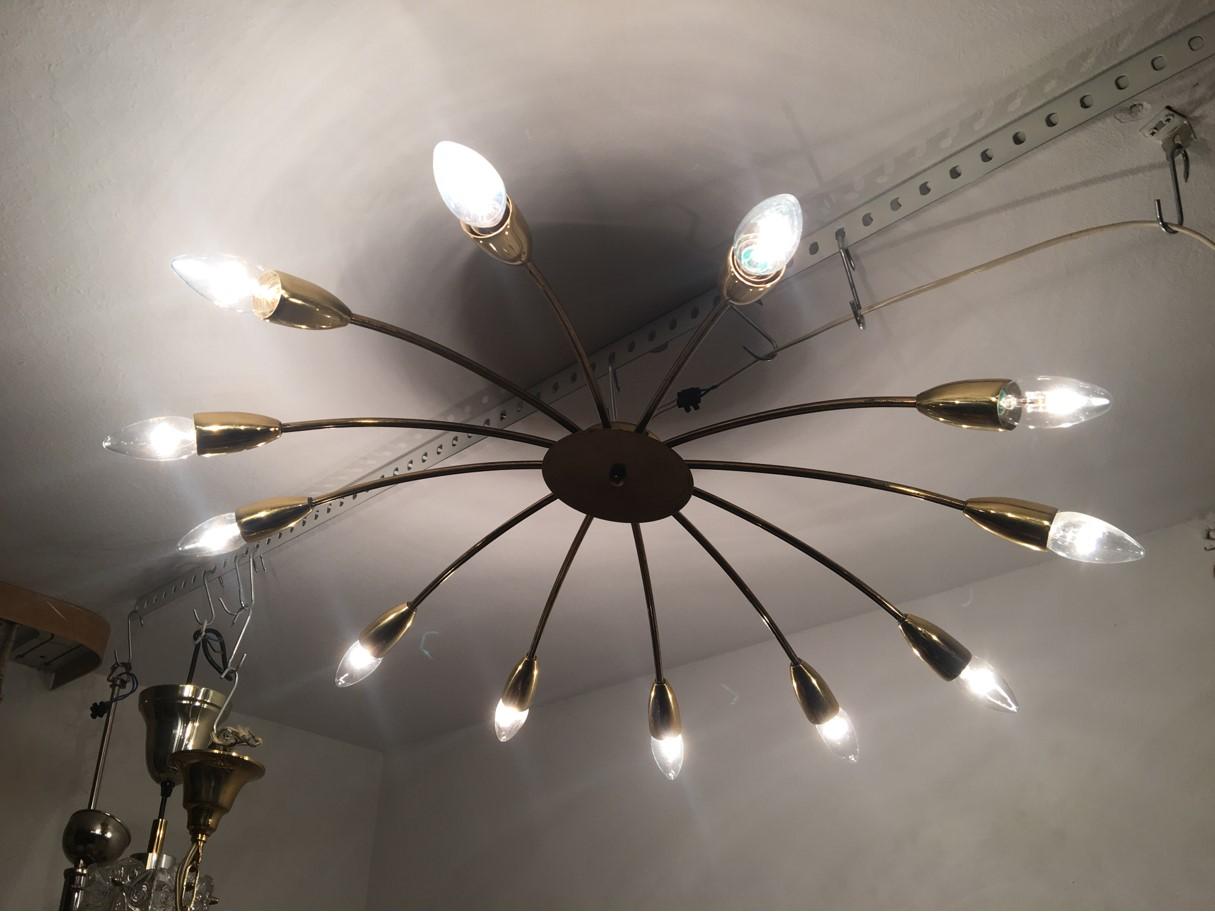 From the 1960s. A lovely 12 armed Sputnik flush mount chandelier from Austria. The fixture requires twelve European E14 candelabra bulb, each bulb up to 40 watt in good working condition. Equipped with original 20th century European wiring. We