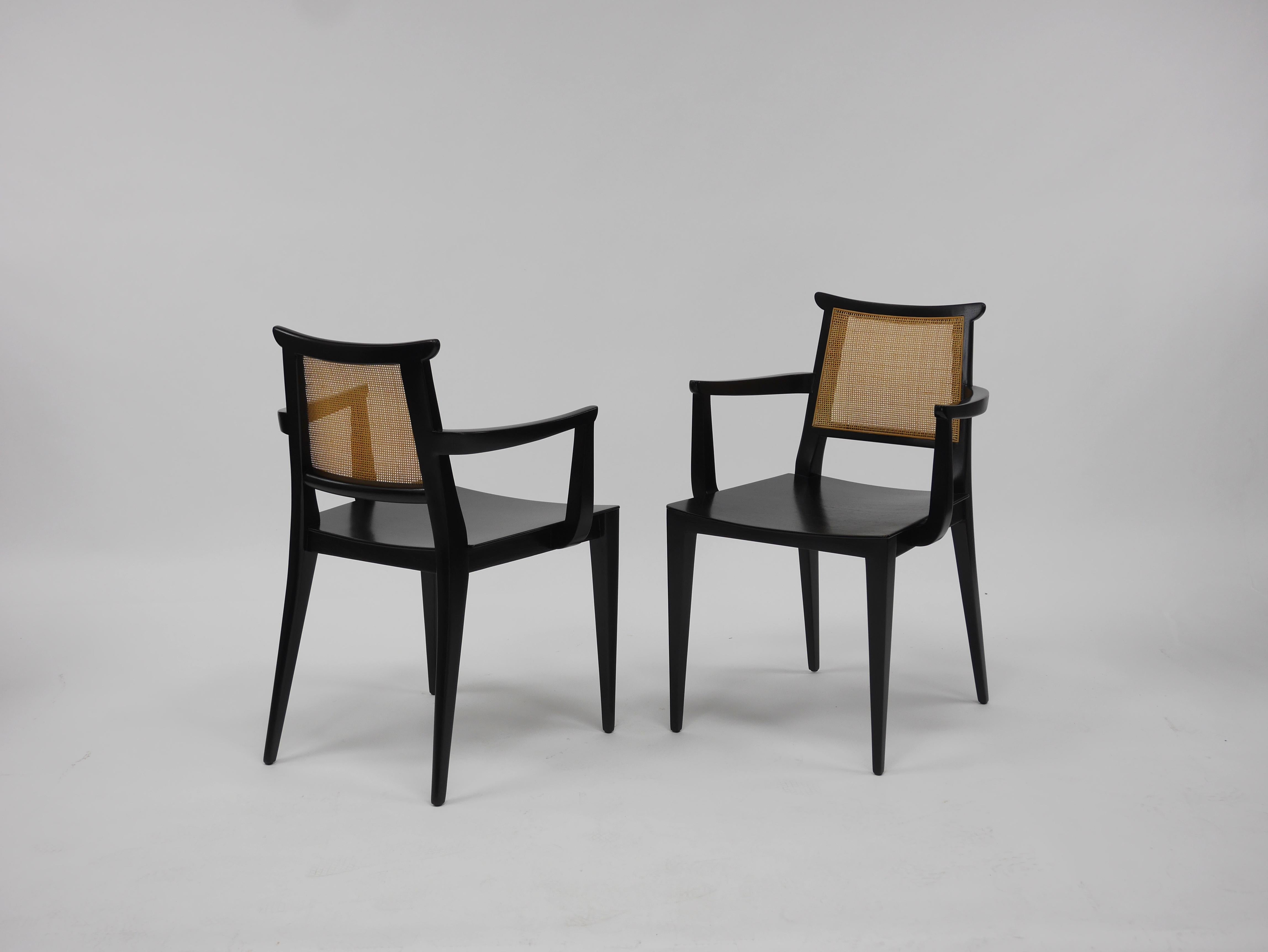 Eight dining chairs by Edward Wormley for Dunbar. Two arm chairs, six side chairs. Having slightly curved mahogany seats, mahogany frames and caned backs. Recent professional restoration including re caning. Marked Dunbar.