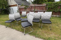 Twelve cantilever black and white dining or conference chairs on chrome base