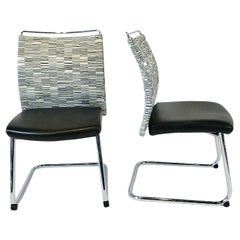 Twelve cantilever black and white dining or conference chairs on chrome base