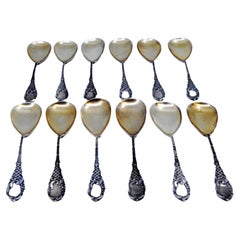 Twelve coffee spoons with gilt shells and embossed handles with monograms