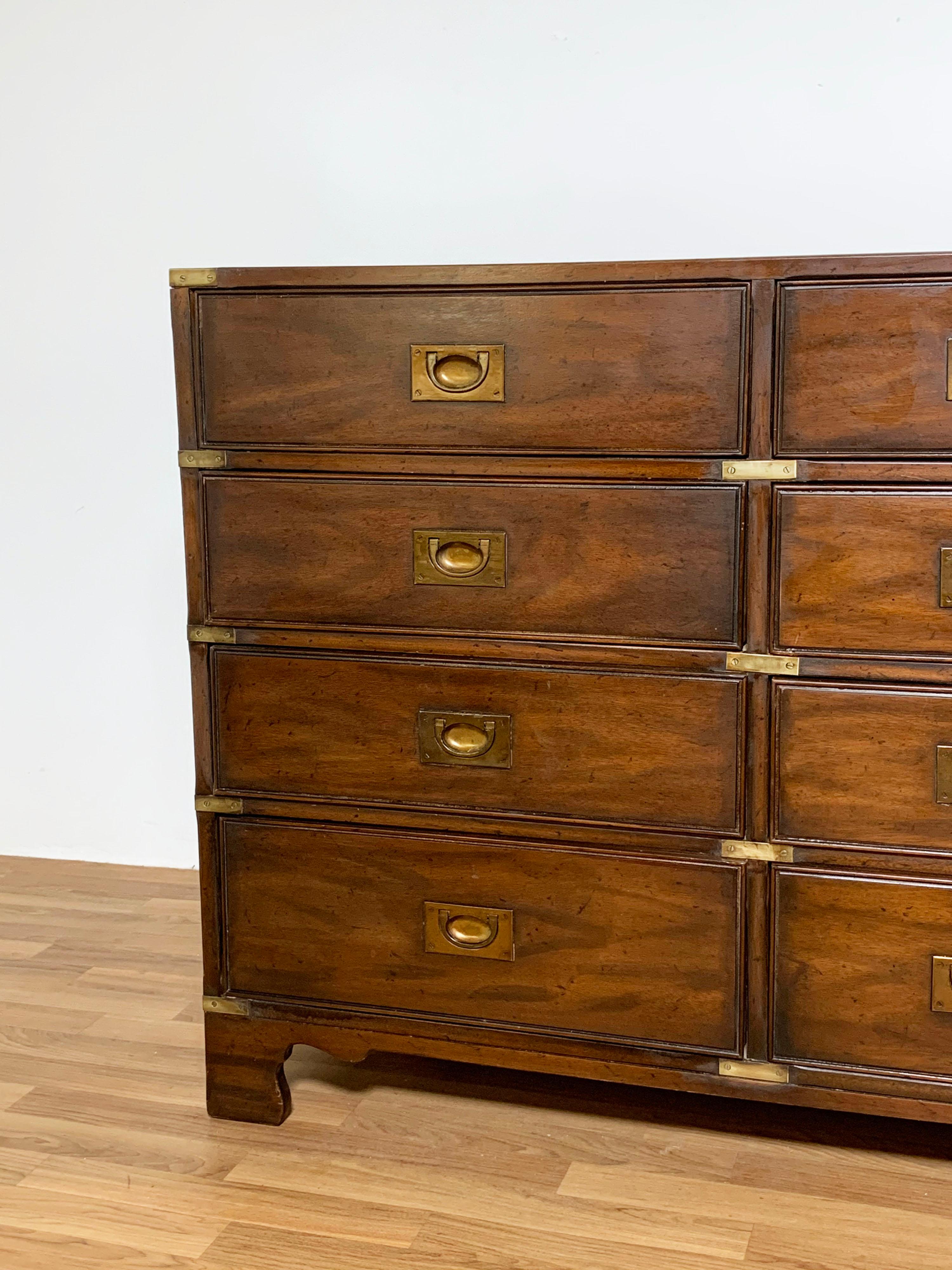 A long campaign style chest with twelve drawers in walnut with brass accents by Heritage Henredon, ca. 1960s.
