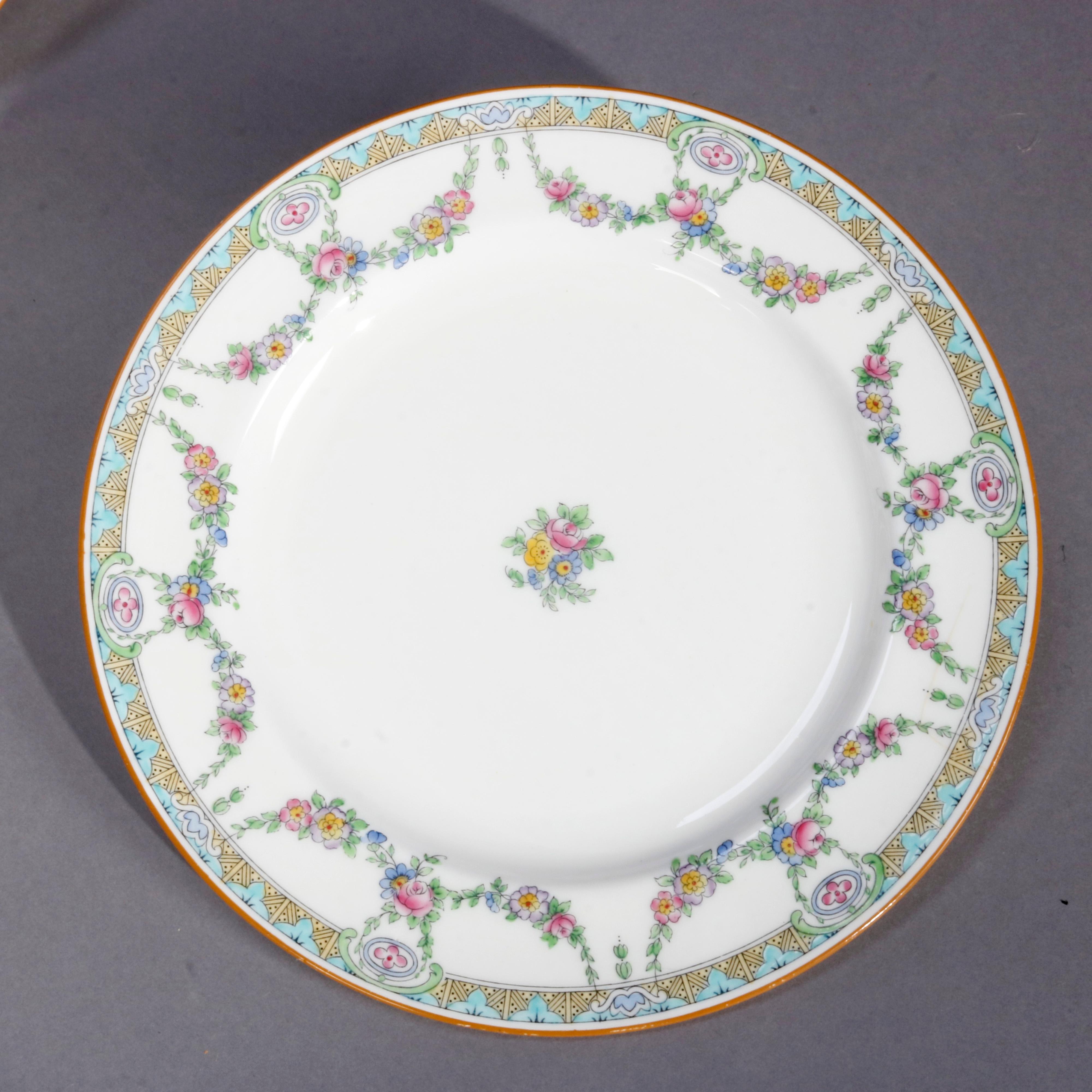 A set 12 English Mintons fine China dinner plates feature rim with floral swag and stylized foliate border, central floral spray, en verso crown maker mark as photographed, 20th century.
  

Measures- 0.88
