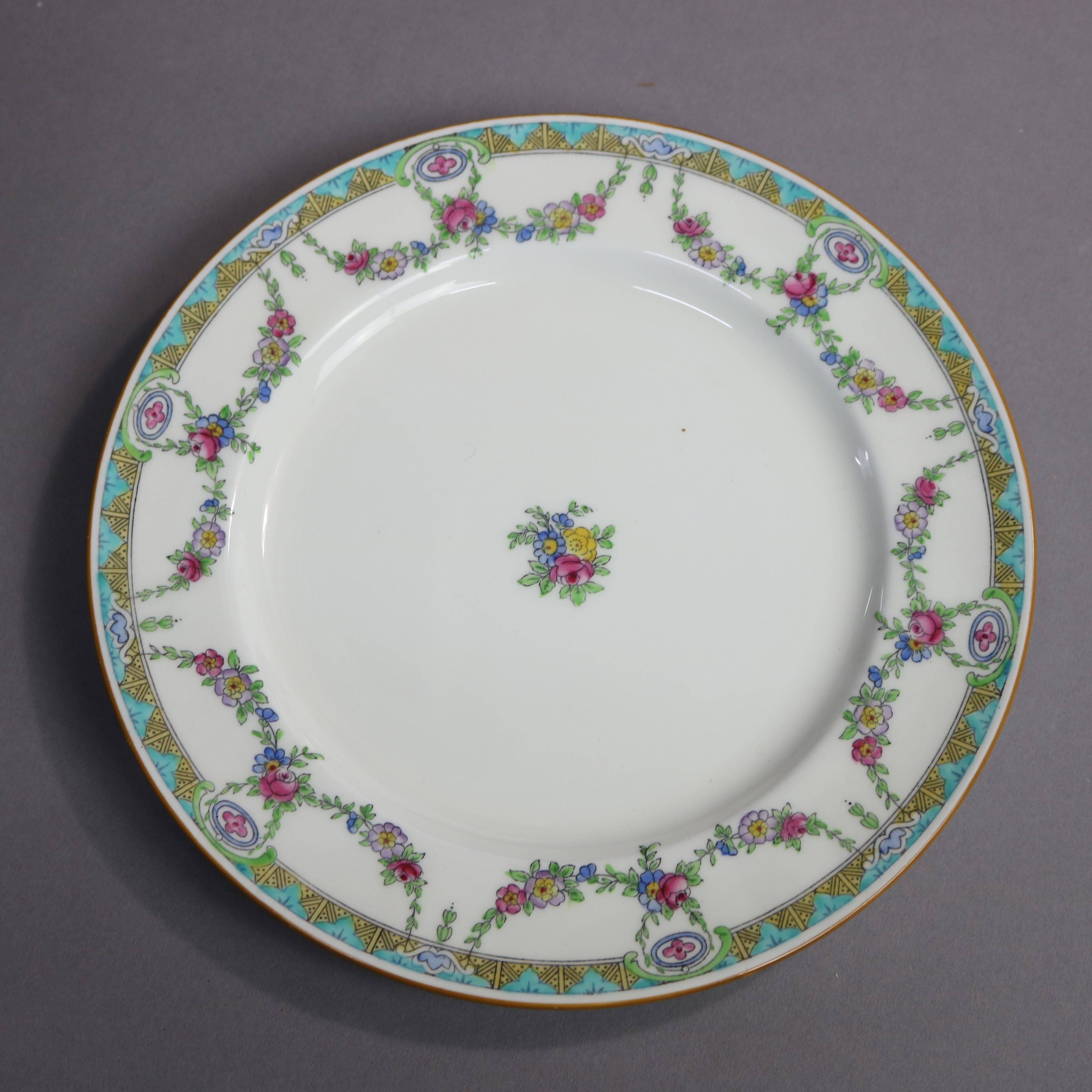 A set of 12 English Mintons Fine China salad plates feature rim with floral swag and stylized foliate border, central floral spray, en verso crown maker mark as photographed, 20th century

Measures- .75