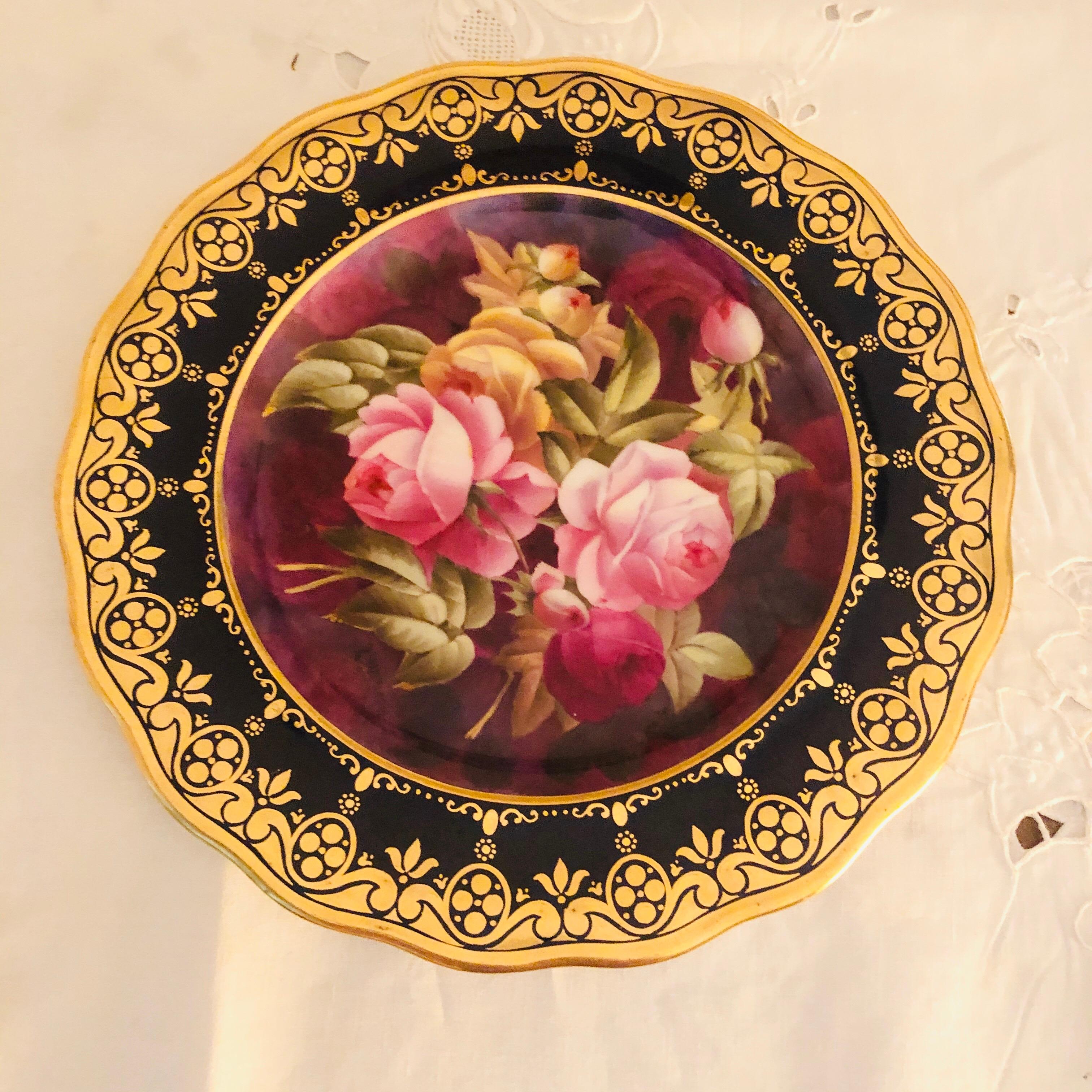 Set of twelve exceptional rose plates, each painted with different roses Artist-signed Harrison. The paintings of roses are surrounded by a gold decorative border on a cobalt blue base. These were exclusively made for Bailey, Banks & Biddle Company