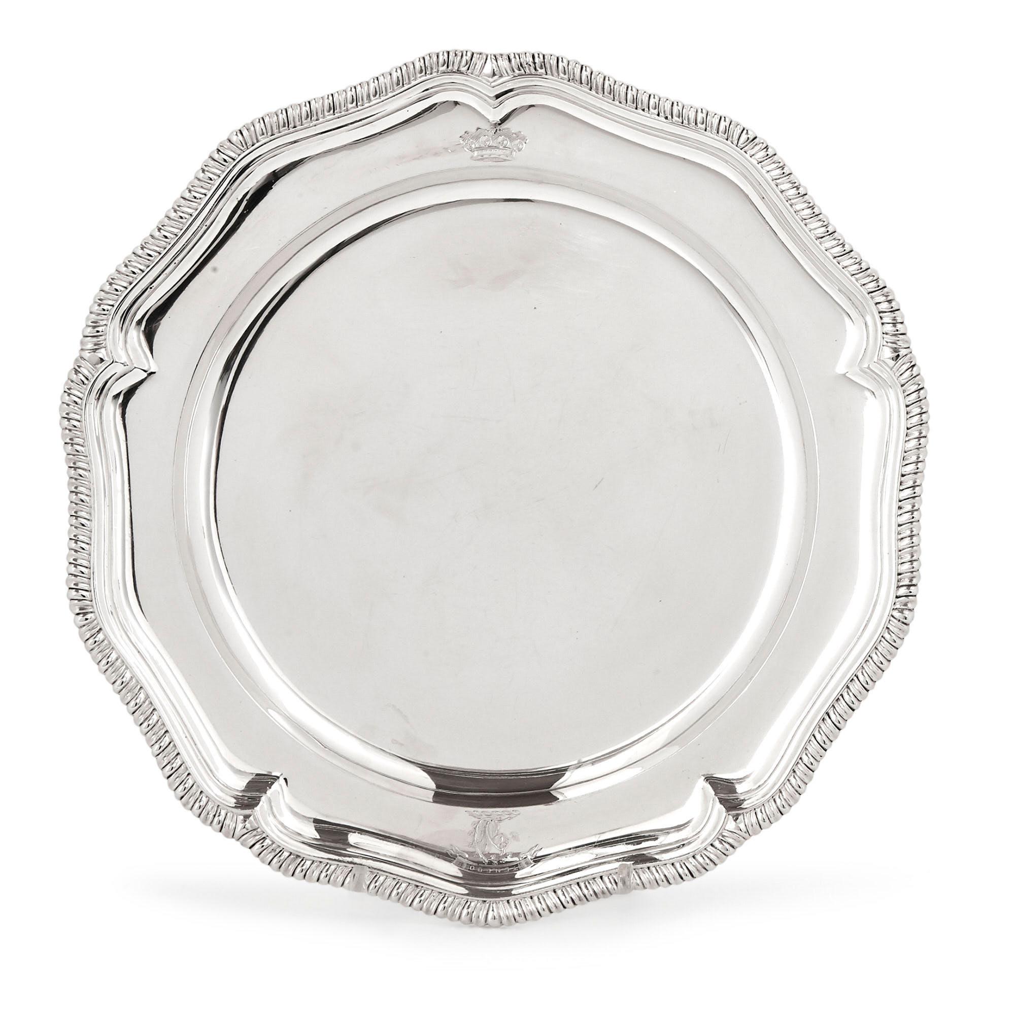 Manufactured in 1782 by the accomplished English silversmith Charles Wright, this set of twelve silver dinner plates is of superb quality. Each plate is largely circular, though the profile of each plate is actually polygonal, featuring five pinched