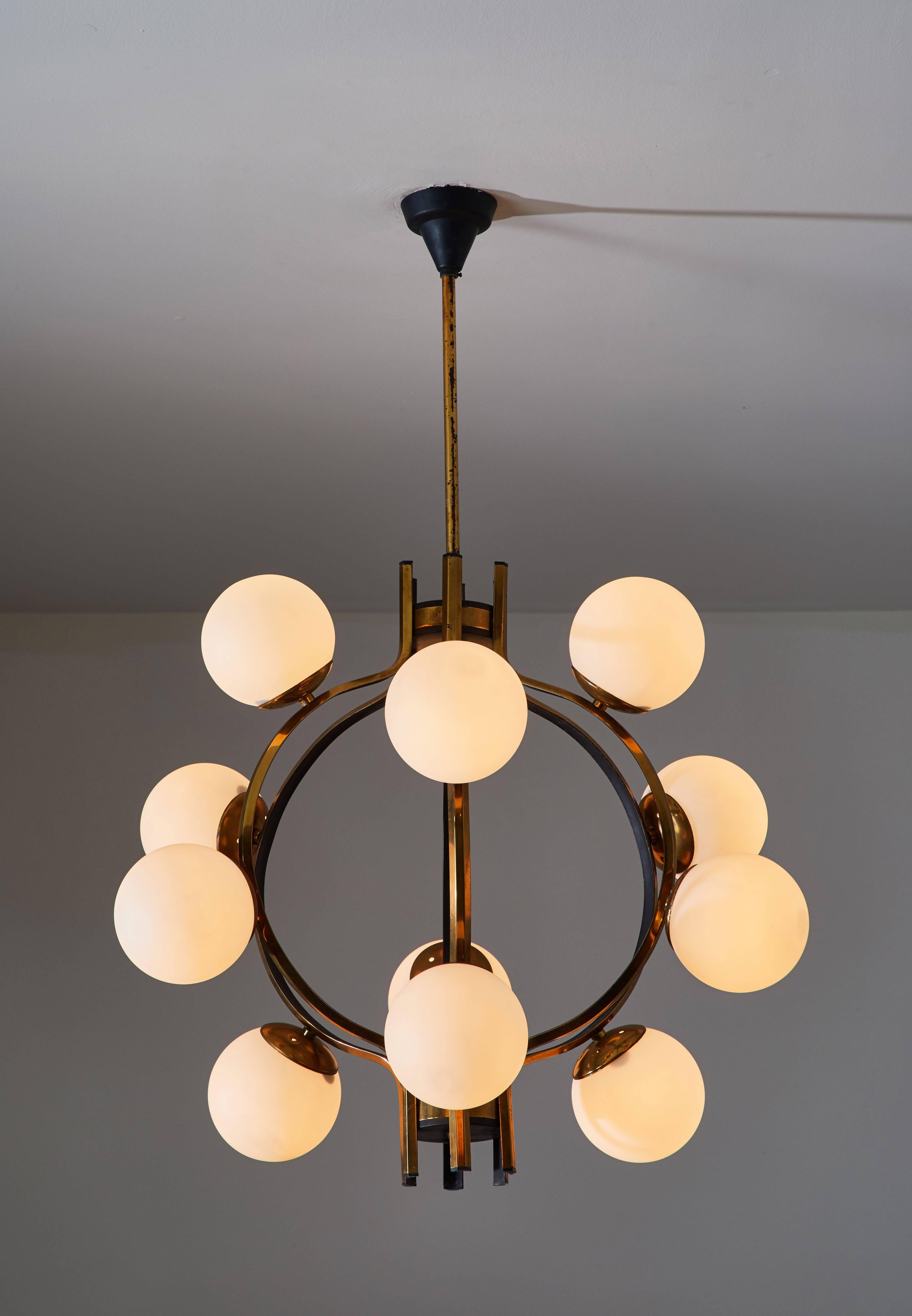 Twelve globe chandelier manufactured by Stilnovo in Italy circa 1950s. Brass, enameled metal and brushed satin glass globes. Wired for US junction boxes. Original stem and canopy. Overall drop can be adjusted. Each globe takes one E14 25w maximum