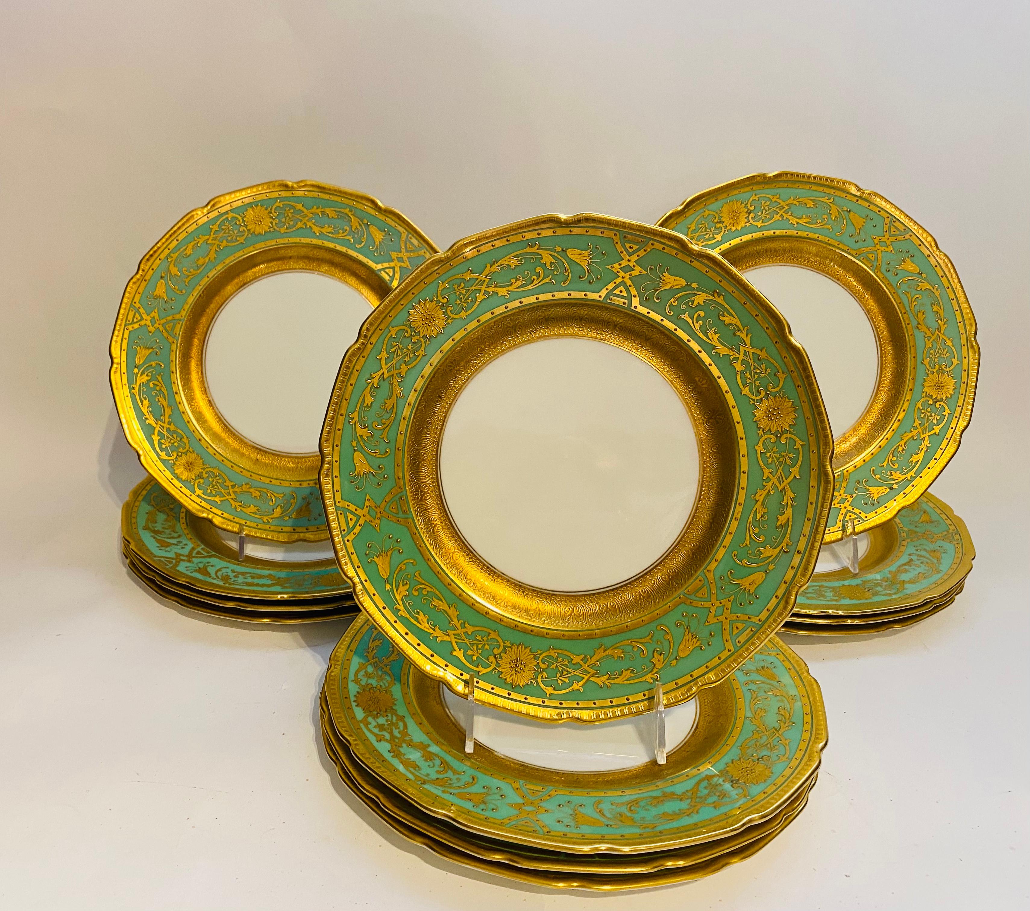 Another beautiful set of 12 dinner plates by Royal Doulton of England. This set features the classic Robert Allen shape and beautiful raised gilding on a vibrant green collar. Double 24 karat gilt bands surround this pretty pattern with the one that