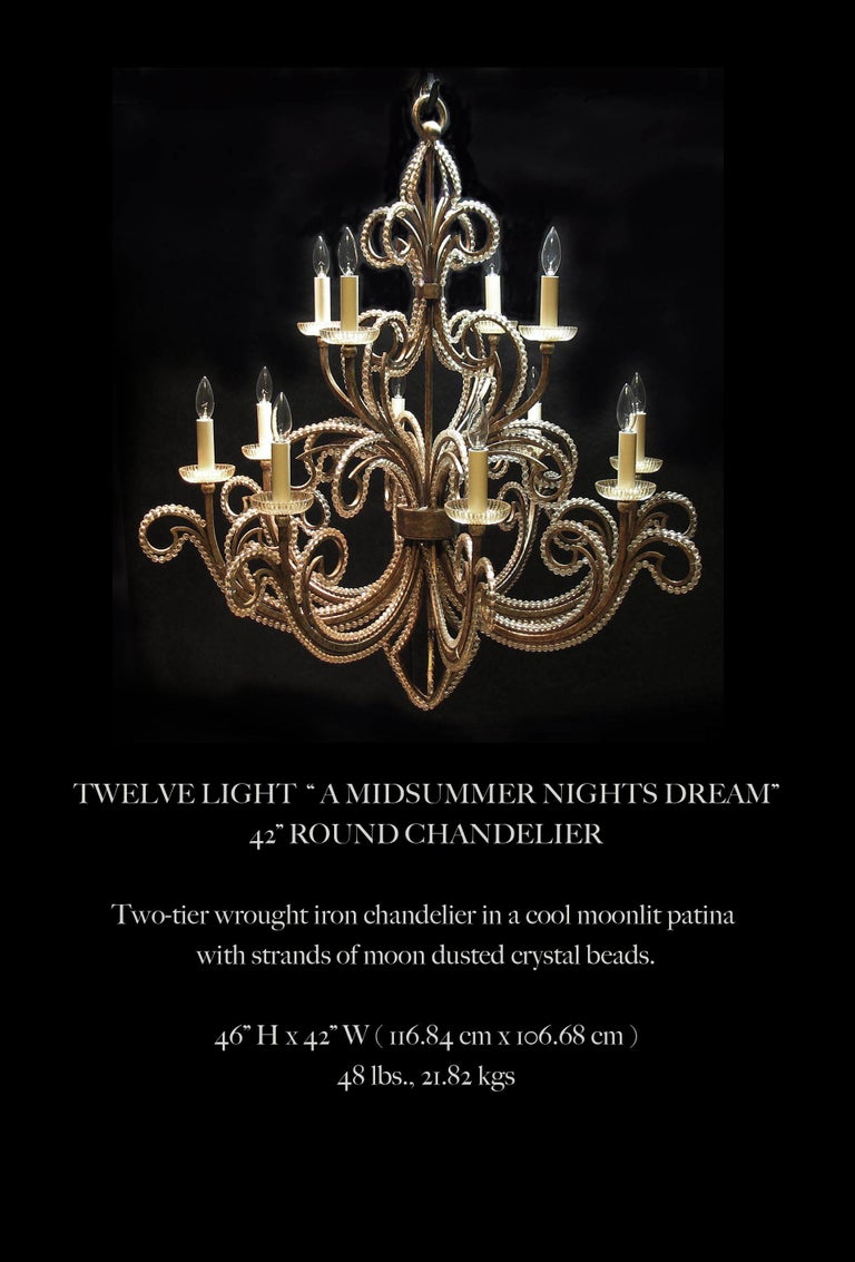 Twelve light “A Midsummer Nights Dream”
42” Round chandelier

Two-tier wrought iron chandelier in a cool moonlit patina 
With strands of moon dusted crystal beads.

Measures: 46” H x 42” W ( 116.84 cm x 106.68 cm )
48 lbs., 21.82 kgs.