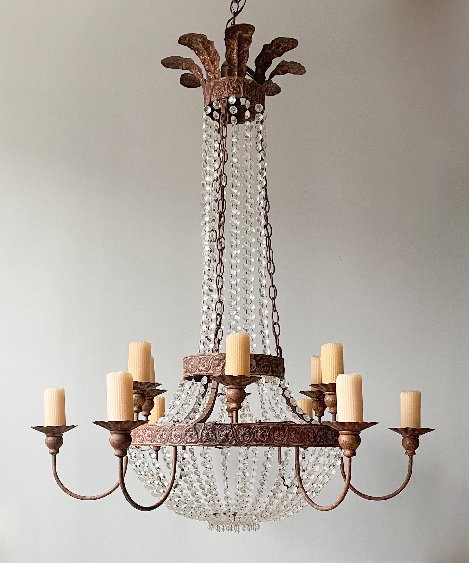 Gorgeous “Iron And Crystal Chandelier” by Niermann Weeks in the Empire style. 

The chandelier features an iron frame with repoussé details and a beautiful, distressed “antique gilt” finish. A multitude of crystal beaded strands gracefully drape