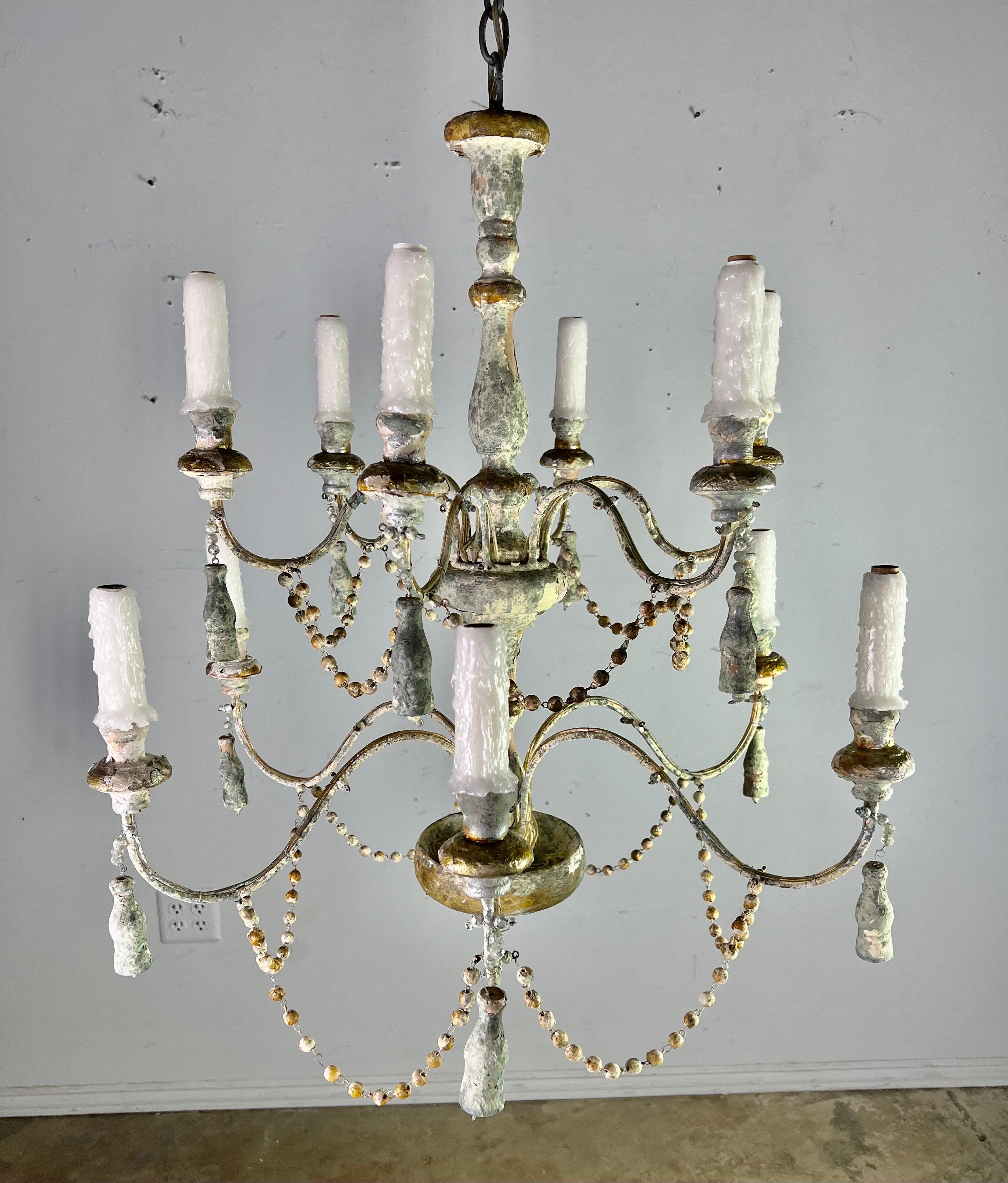 We make these fixtures from antique elements we find on our trips to Italy and France. The fixtures are all hand made and each pair are different depending on the client's needs or our inspiration. The twelve light chandelier is made with real wood