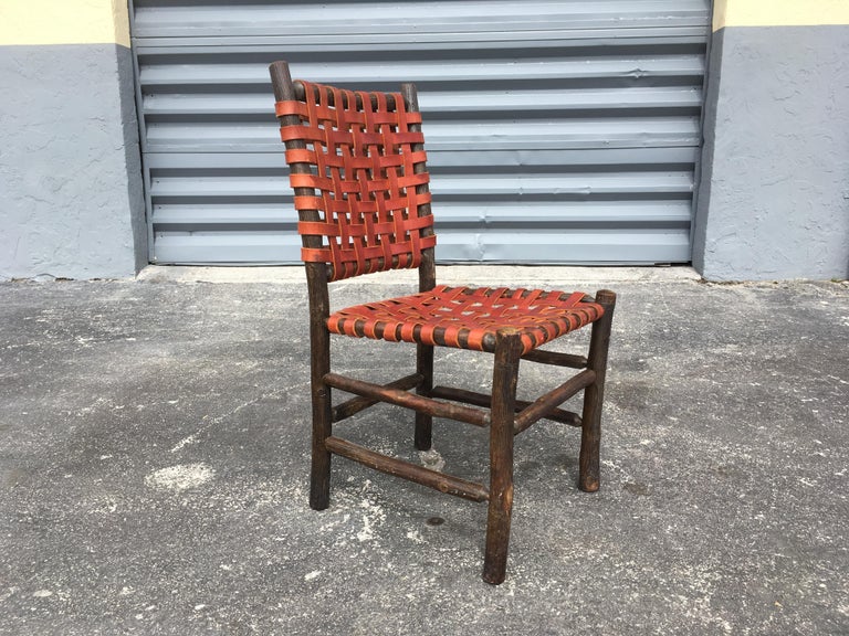 Twelve Old Hickory Dining Chairs with Woven Cognac Saddle Leather For