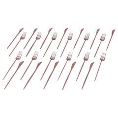 Twelve-person modernist dinner cutlery set in brass.