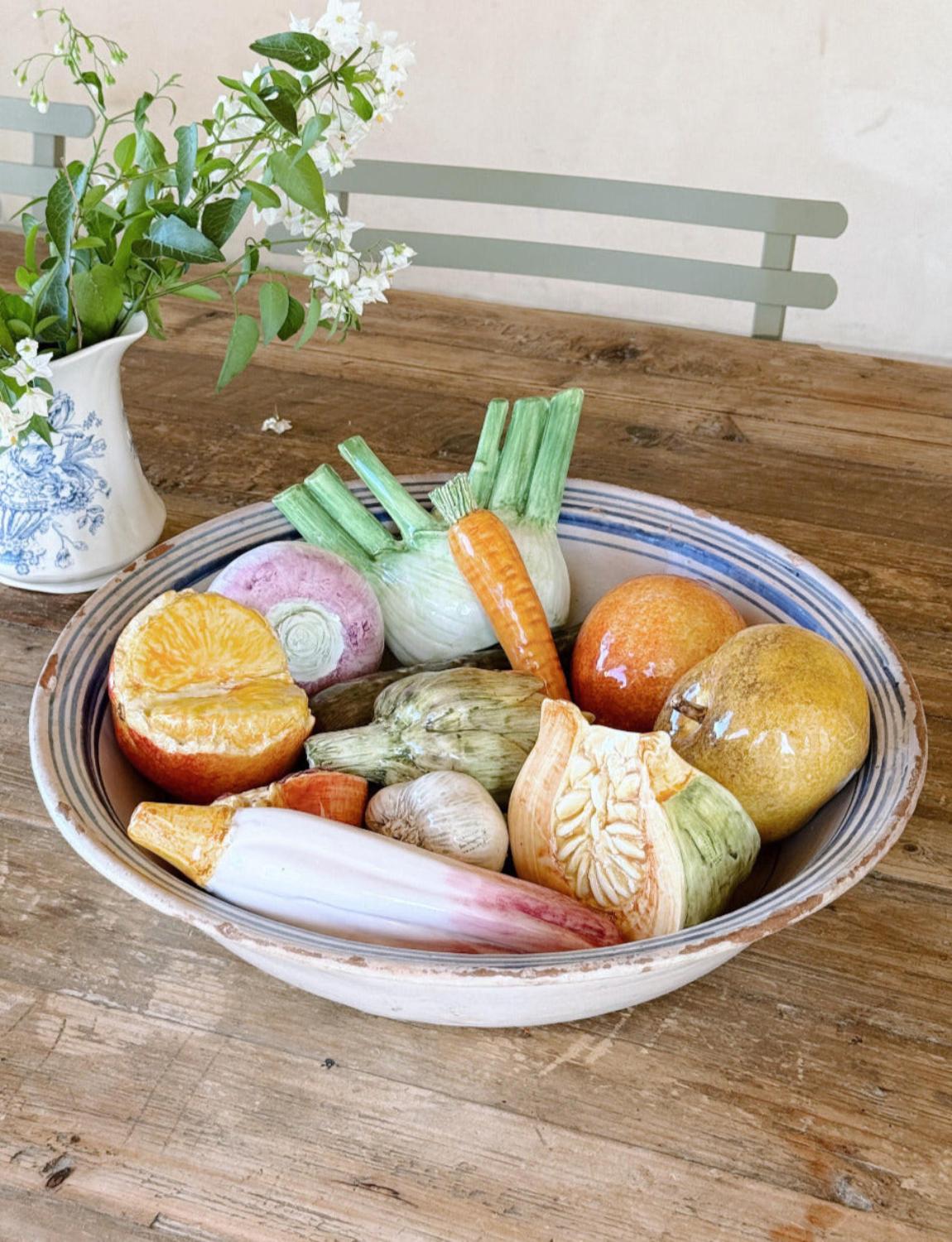 An exceptional twelve piece set of ceramic fruit and vegetables made by the renowned Italian ceramics house, Vecchia Lodigiana in the 1970s. The pieces include fennel, garlic, pomegranate, orange, radicchio, beetroot, pear, carrot, pumpkin and