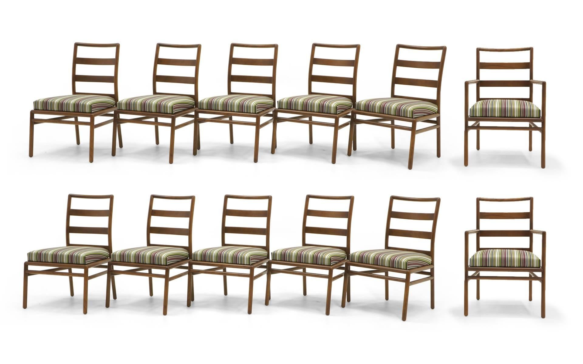 Set of 12 T.H. Robsjohn-Gibbings dining chairs for Widdicomb. Completely restored and reupholstered in Paul Smith stripe fabric by Maharam. These are wide, extremely well made and sturdy ladder back chairs. A beautiful set. Ten armless side chairs