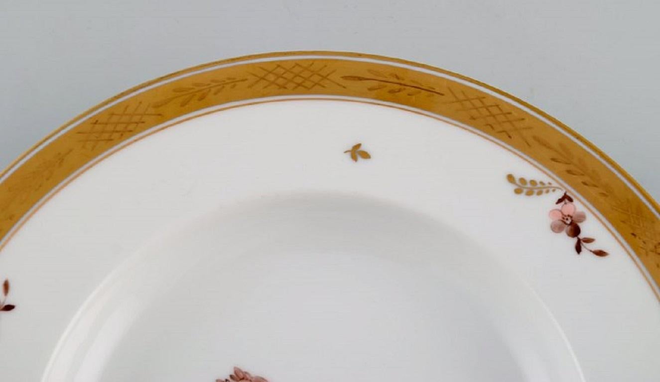 Hand-Painted Twelve Royal Copenhagen Gold Basket Deep Plates in Porcelain with Flowers For Sale
