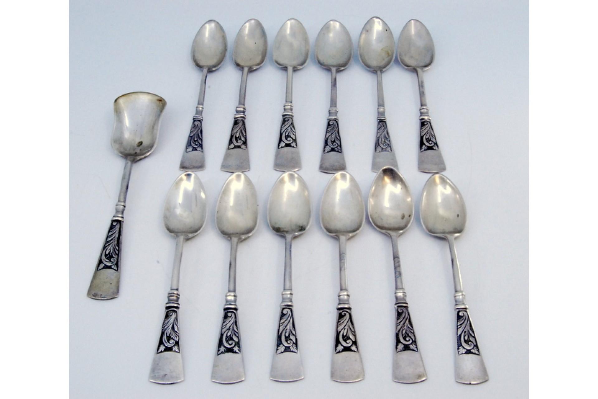 European Twelve silver coffee spoons and sugar shovel with patinated relief handles For Sale