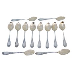Twelve silver ice cream scoops with gilt engraved shells and raised handles
