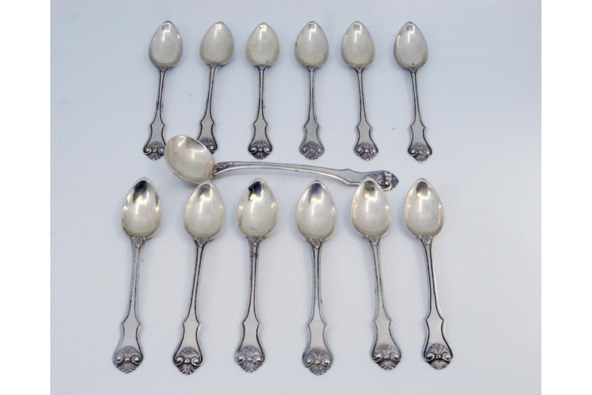 Description: Set of twelve teaspoons and sugar shovel in silver with applications and shells on the handles. Metal: Silver. Origin: Portuguese. Brand: Porto Coroa. Weight: 306.75 grams (Set of twelve spoons and shovel). Dimensions: Shovel -