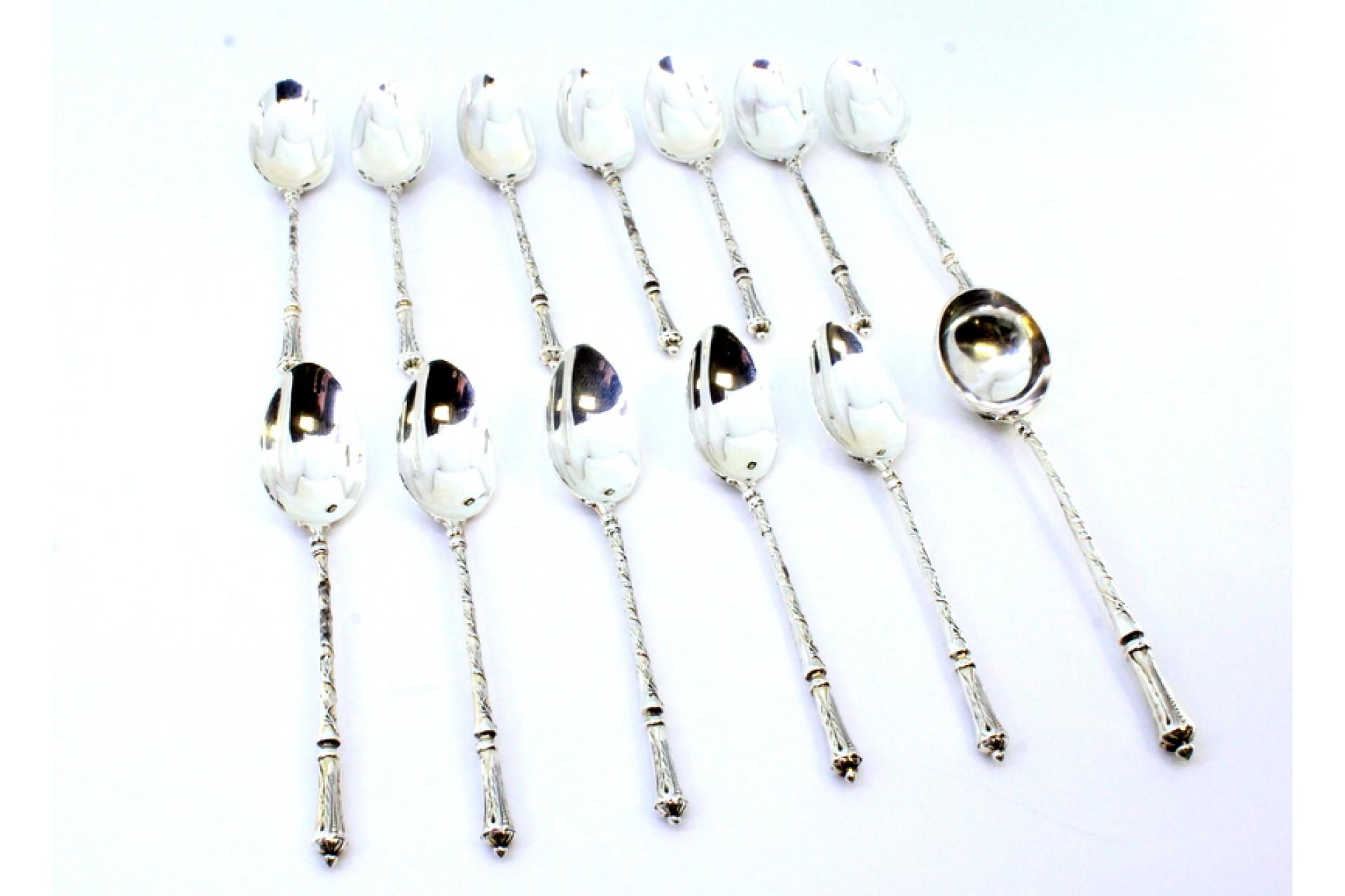 European Twelve silver teaspoons and sugar shovel with friezed relief handles For Sale