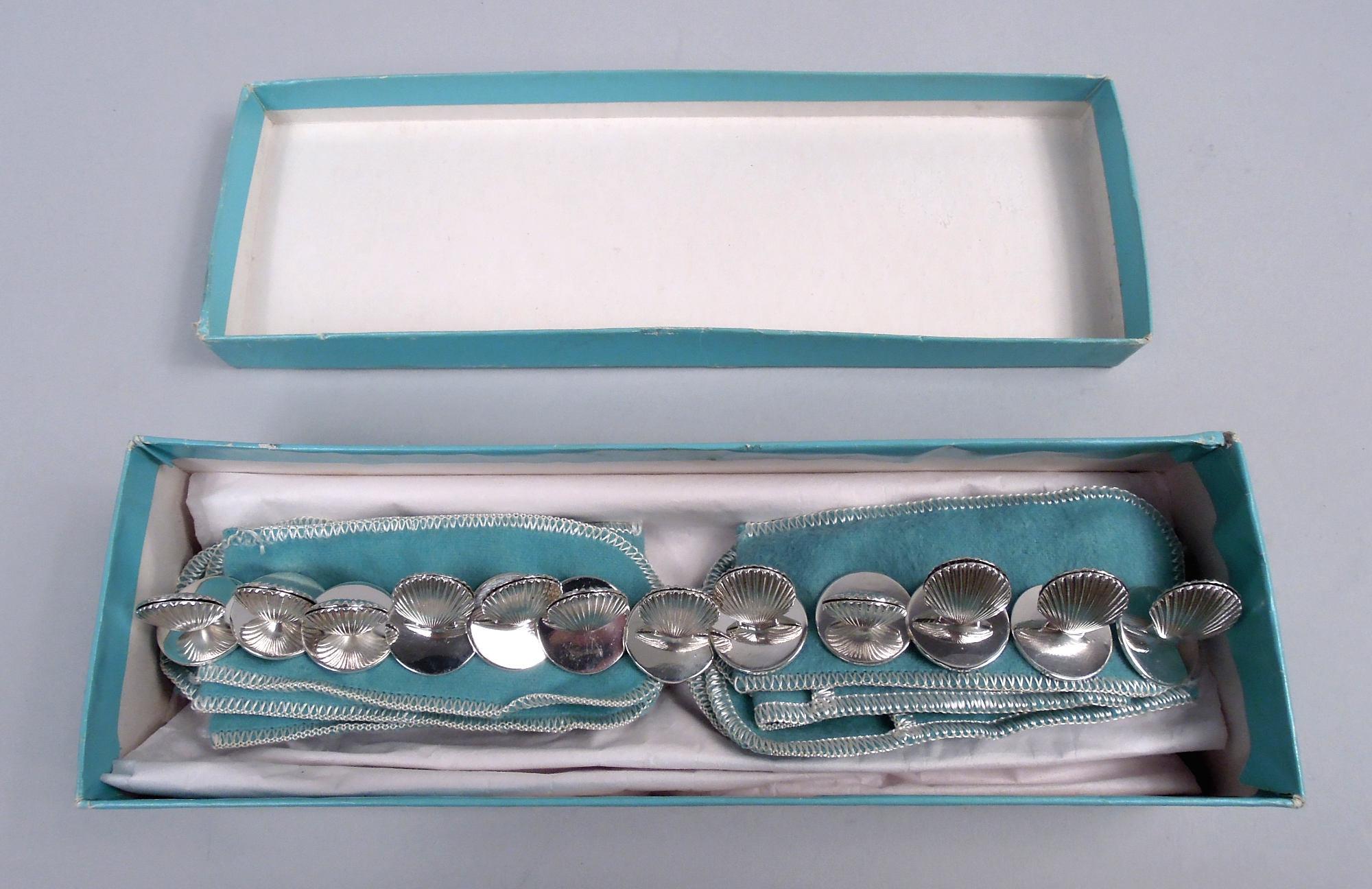 Set of 12 Midcentury Classical sterling silver place card holders. Made by Tiffany & Co. in New York. Each: Double-sided vertical scallop shell mounted to round flat base. With original eggshell blue pouches and box. Marked “Tiffany & Co / Makers /