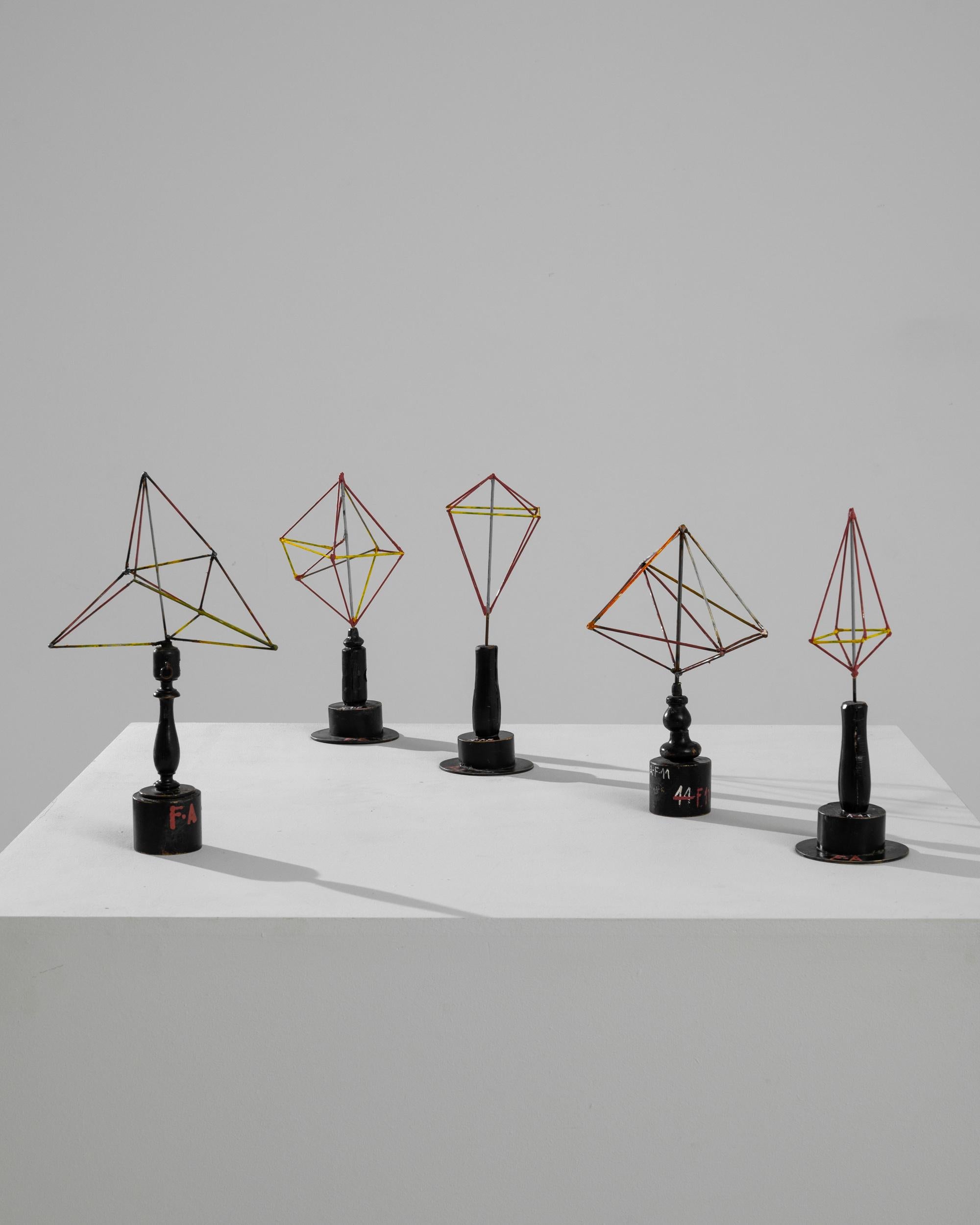 A vintage set of five metal decorative objects with wooden bases created in Czechia. Expressively applied vibrant paint and exposed welding joints engender a gritty playfulness in these geometric objects. The modern, minimalist forms of the metal