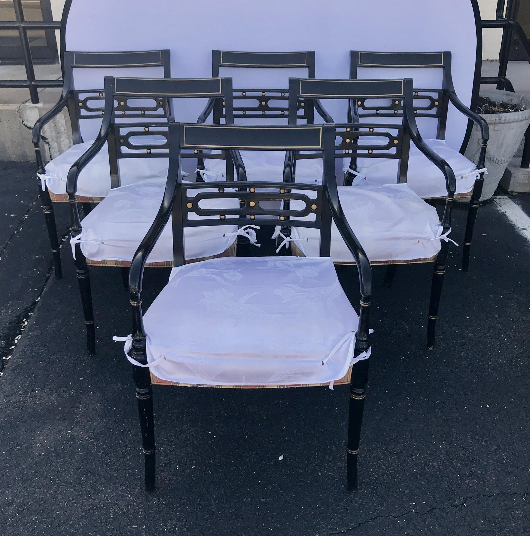 Stunning set of six English Regency style black ebonized dining room chairs. Finely handcrafted in the 20th century, the result is one of unmistakable elegance and, with their graceful lines and exquisite finish, this set of English Regency style