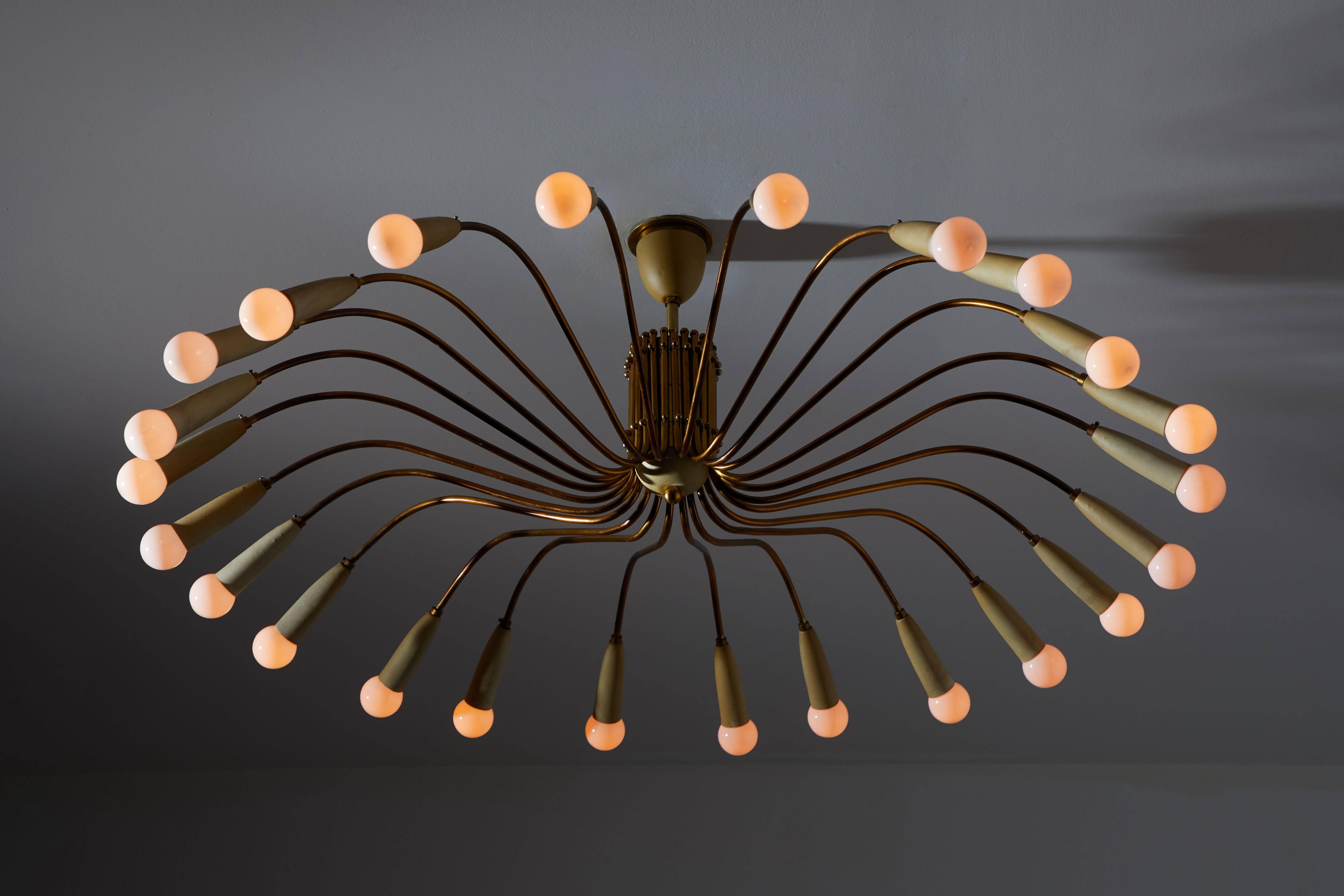 Twenty-four-arm chandelier manufactured in Italy, circa 1950's for LUMI.  Wired for US junction boxes. Brass and enameled metal shades. Original canopy and custom brass ceiling plate. Takes 24 E14 American candelabra 25w maximum bulbs. Overall drop