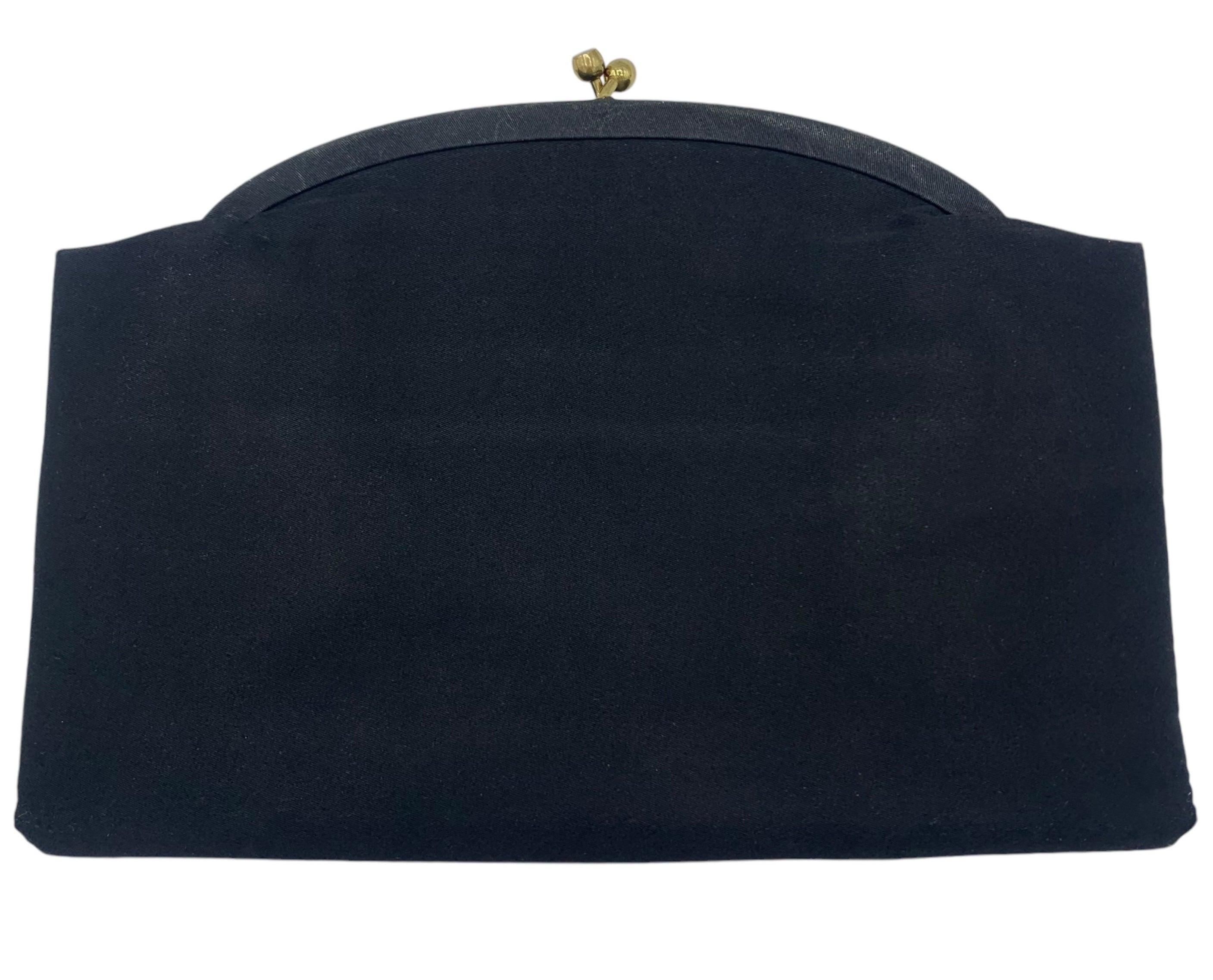 Black satin clutch circa 1950s by Twifaille for Harry Rosenfeld. Floral surface tambour stirch embroidery decorates the front of this evening clutch.The interior is fully lined, and opens with two larger pockets on both sides. Brass kiss lock