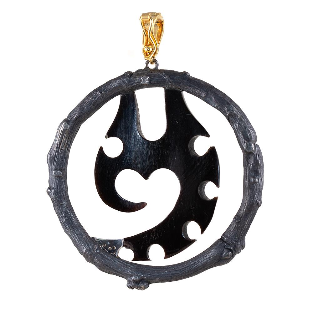 This Time Traveler pendant is composed of carved buffalo horn, framed in black oxidized sterling silver, featuring 18k yellow gold and .07 carat total weight diamonds.

The Body Armor Collection embodies eternal symbols of protection that are both