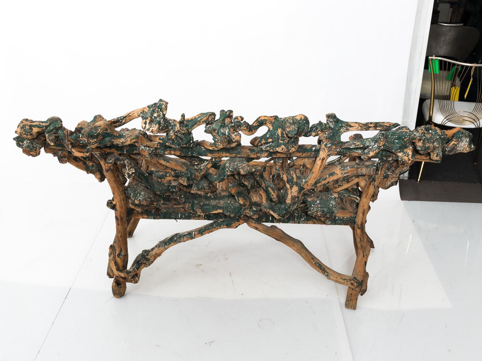 Twig driftwood bench in a carved, rough-hewn finish.