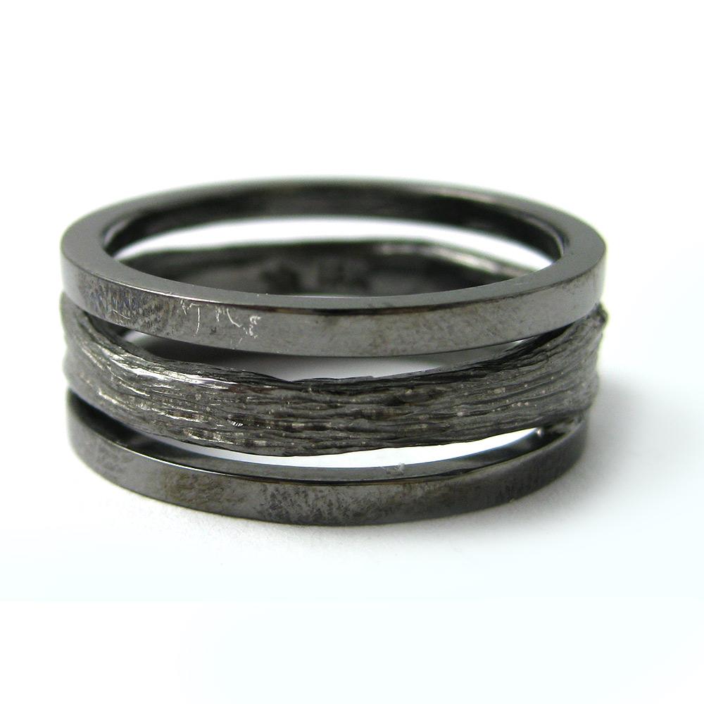 Channeling the eternal Tree of Life, the organic spirit of K. Brunini is captured through this pipe-cut black oxidized sterling silver ring. 

In the Twig Collection, nature exists alongside elegant luxuries, but the lines blur: Rough textures of