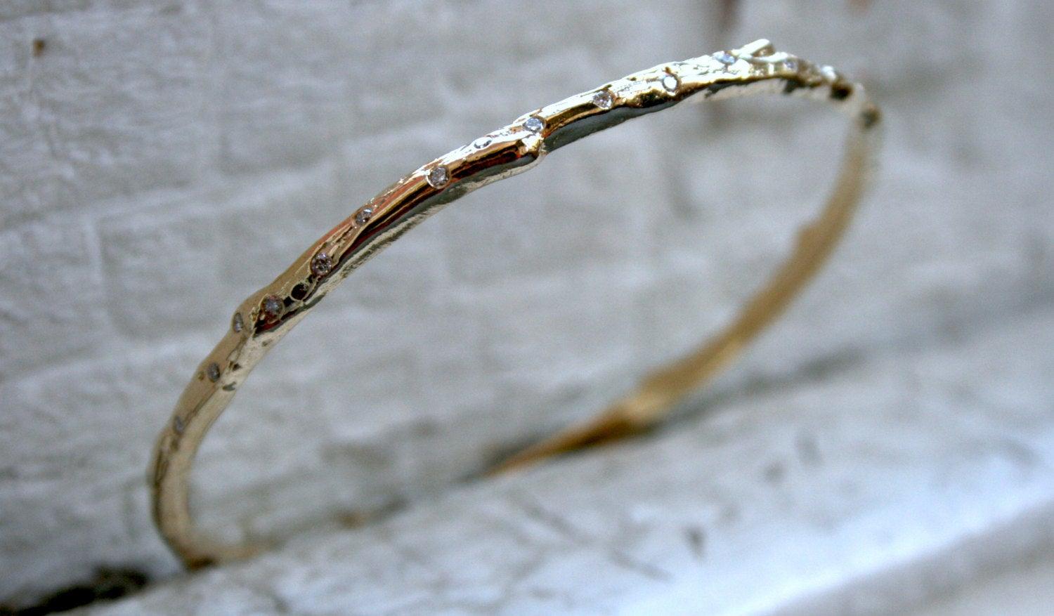 This Twig Style Diamond 14K Yellow Gold Bangle Bracelet is a design I just LOVE! Crafted in any metal, the bangle features gorgeous Round Brilliant Cut Diamonds set in eternity around the bangle! There are a total of 40 Round Brilliant Cut Diamonds,