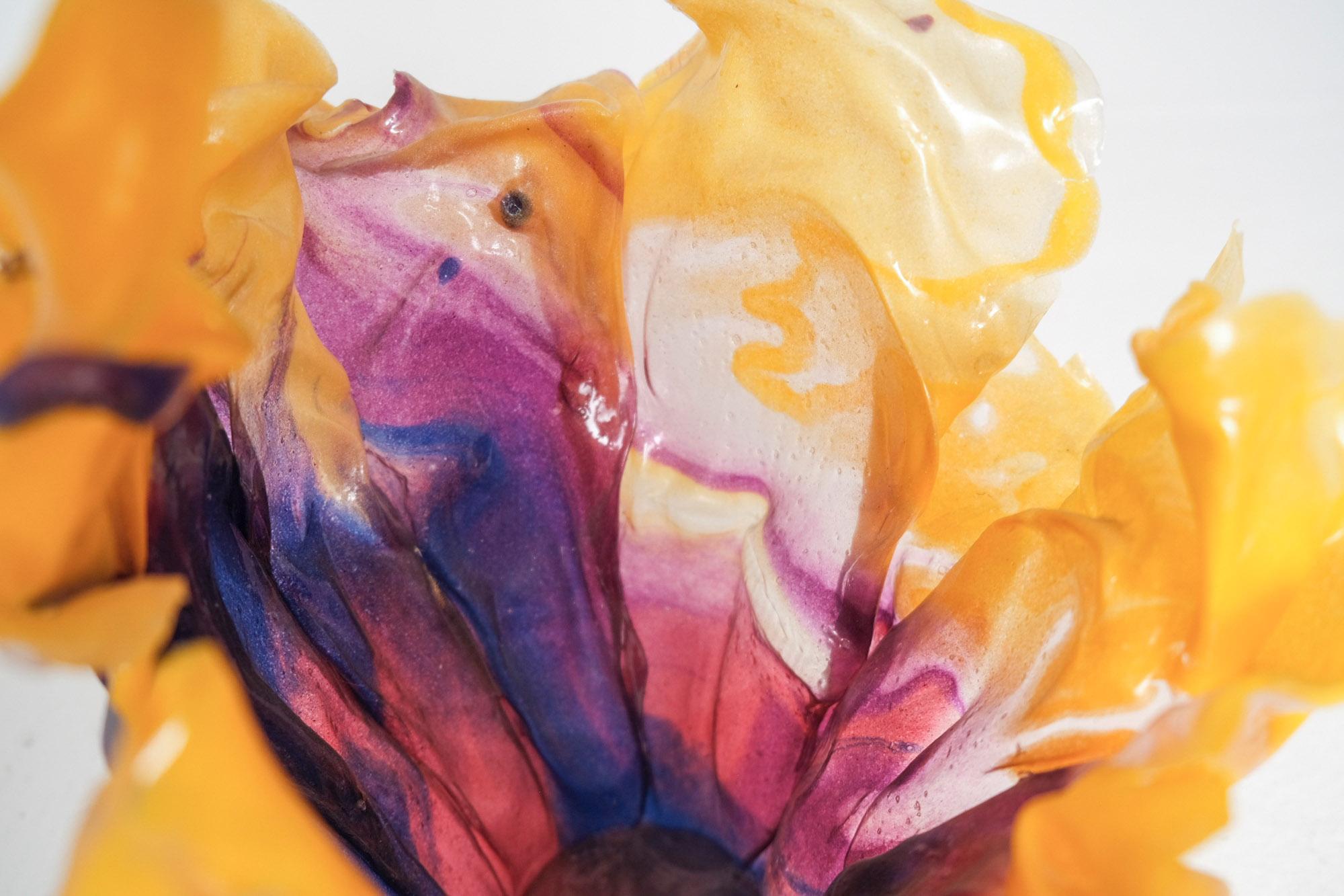 A sculptural epoxy resin vase by contemporary artist Caroline Zimbalist, known for her richly layered colorwork and fluid, organic forms. This hand-shaped vessel features a softly flared silhouette with rippling edges that evoke natural movement,